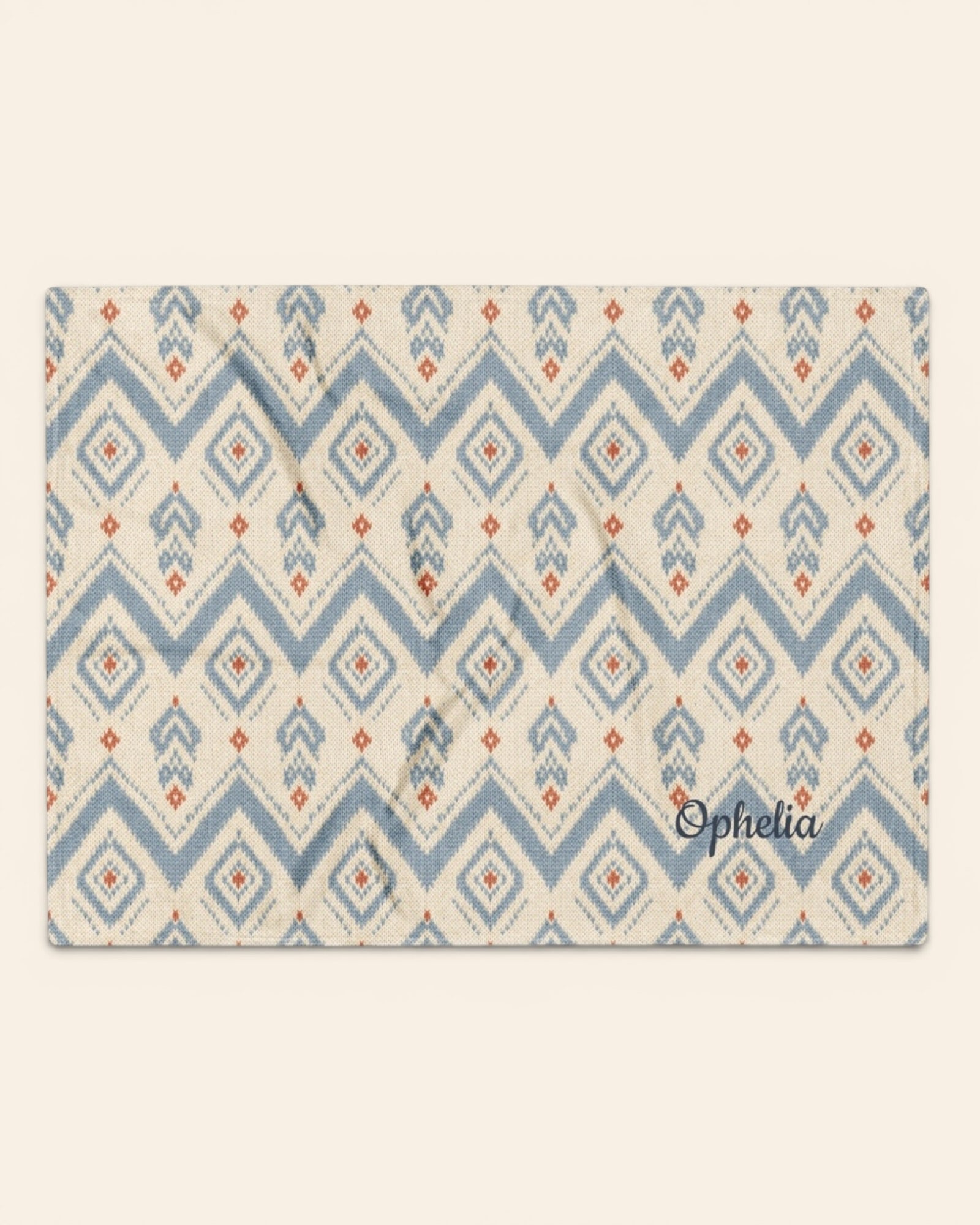 The Alpine Hours Throw Blanket, with mountain-inspired diamonds and rust accents print