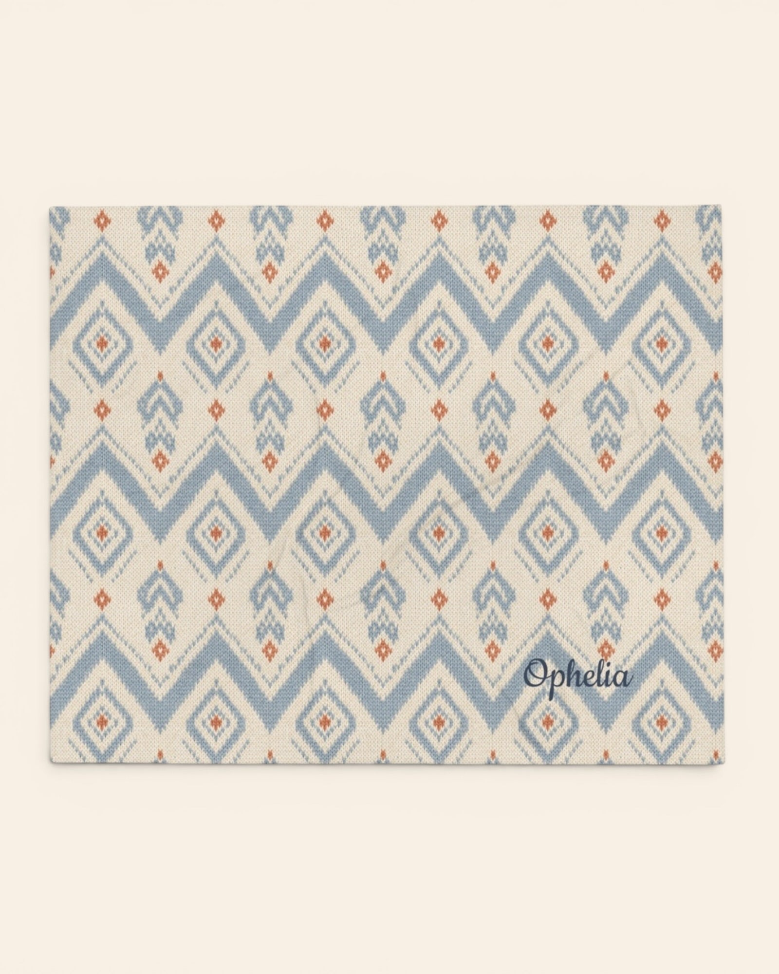 The Alpine Hours Throw Blanket, with mountain-inspired diamonds and rust accents print