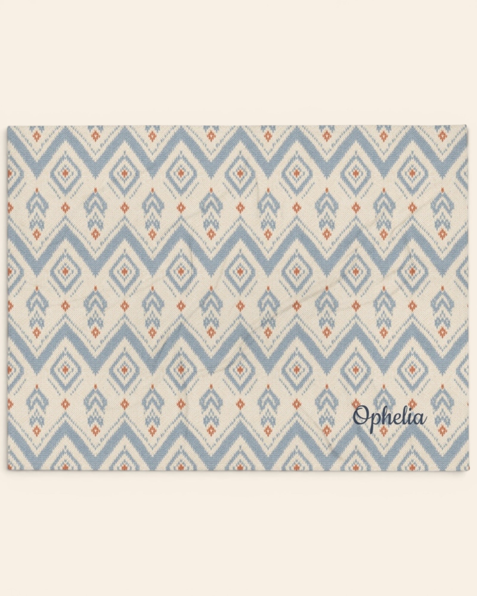 The Alpine Hours Throw Blanket, with mountain-inspired diamonds and rust accents print