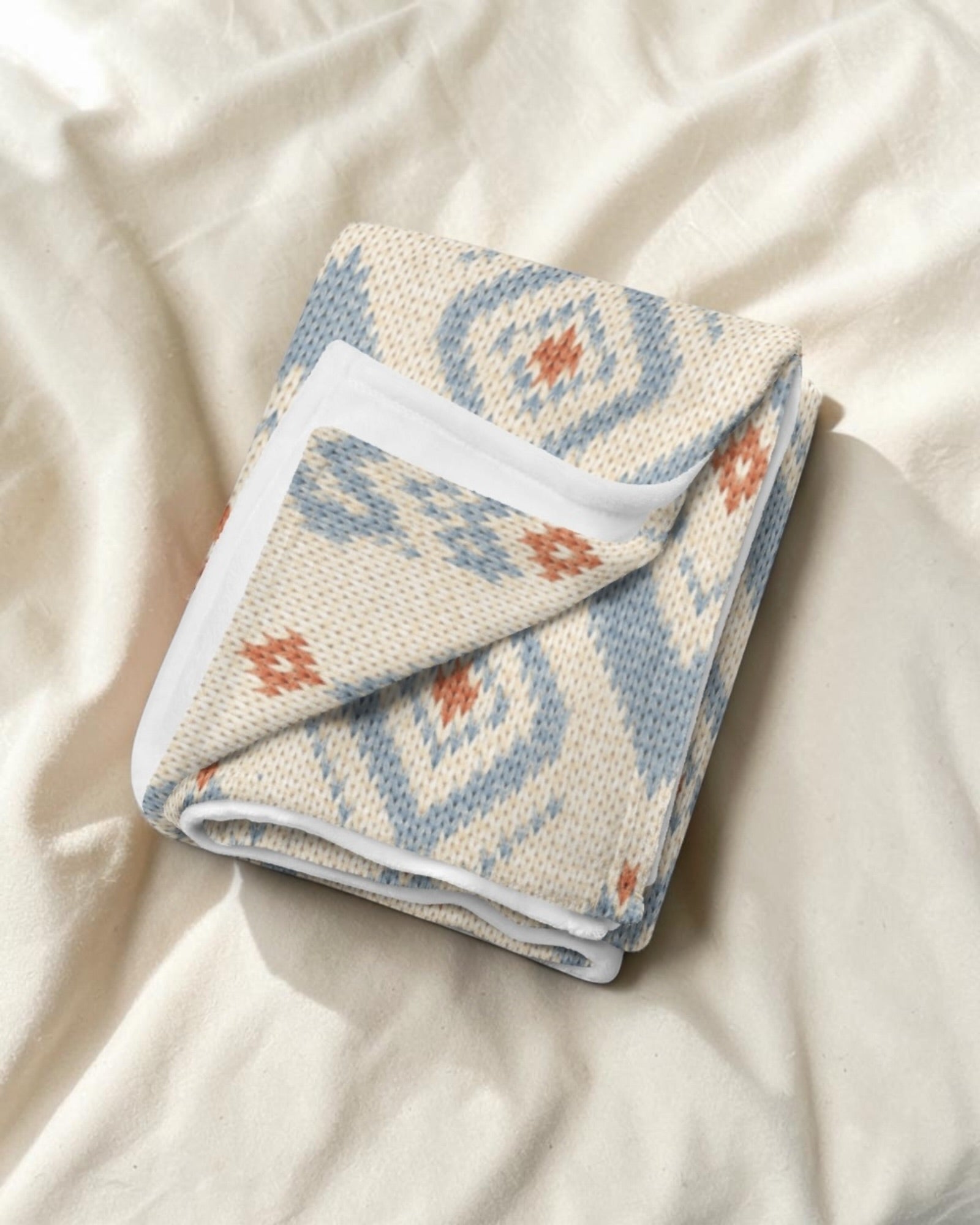 The Alpine Hours Throw Blanket, with mountain-inspired diamonds and rust accents print