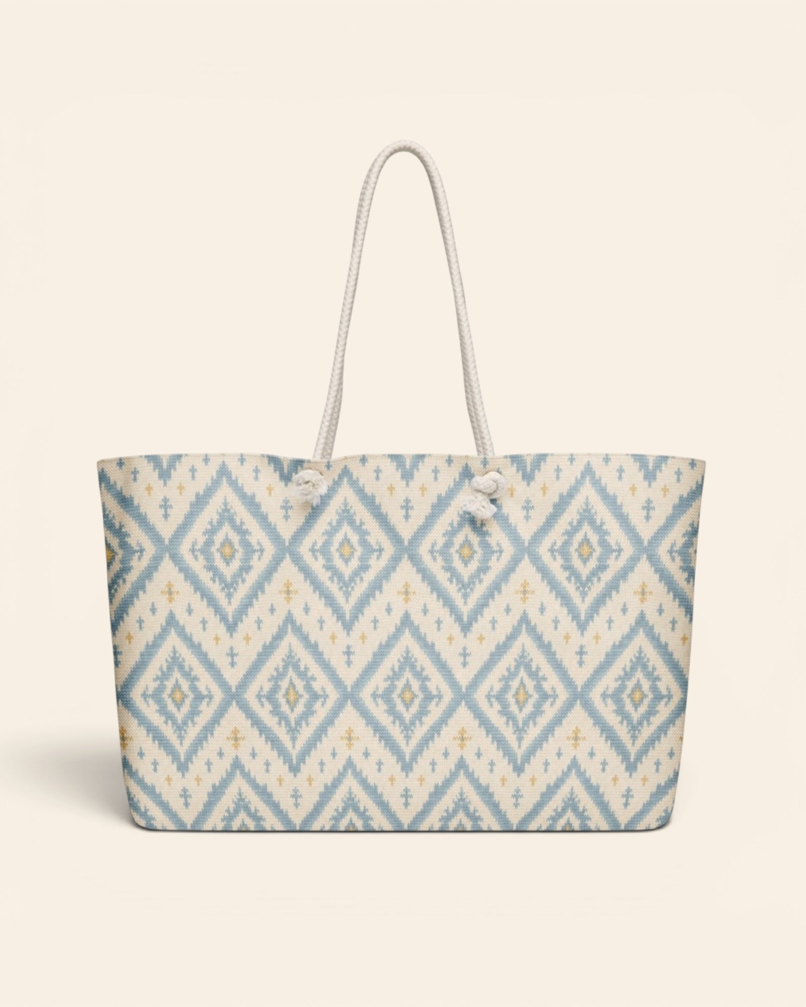 A Place Between The Peaks Weekender Bag, with dusty blue ikat-inspired diamonds and soft golden accents print