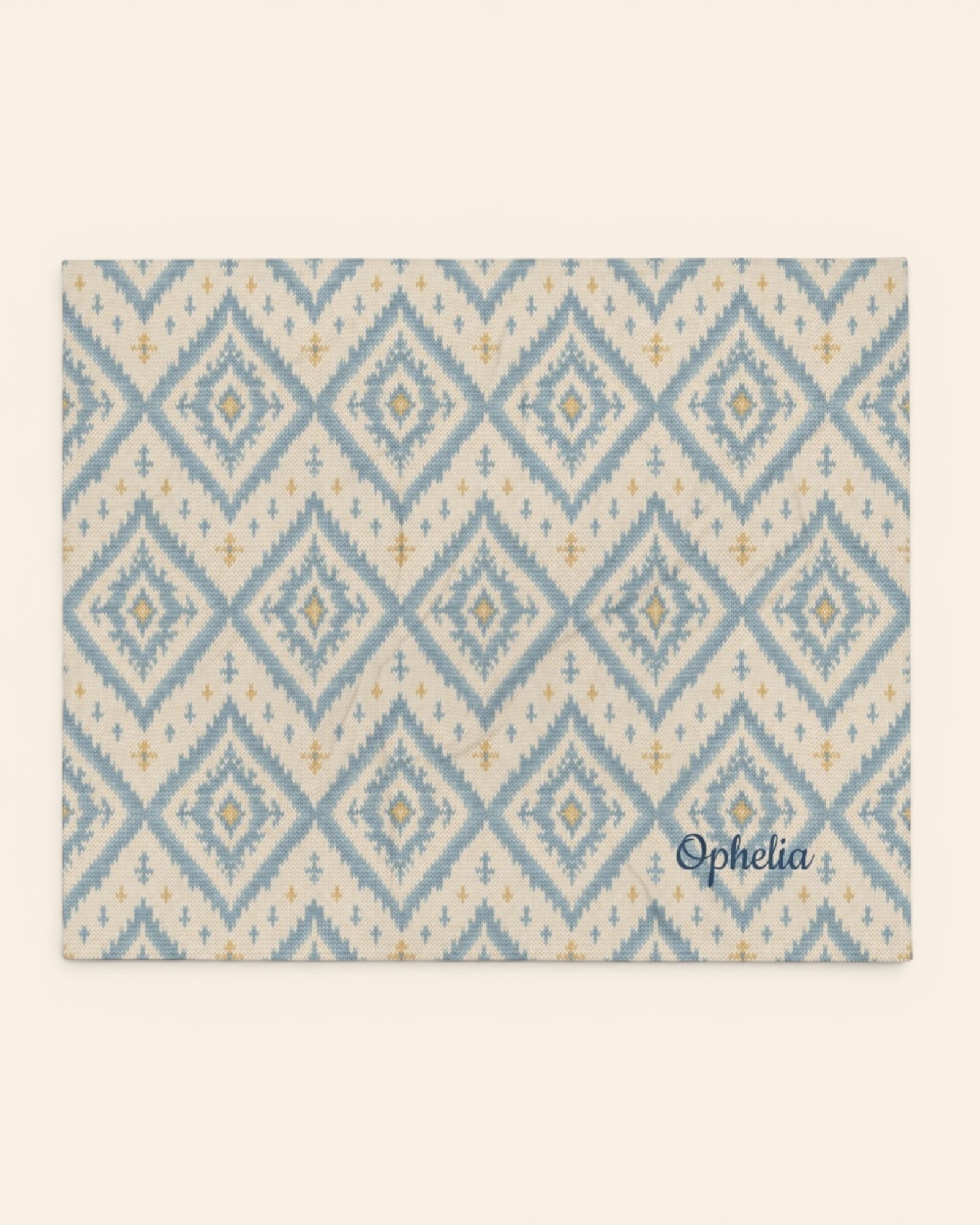 A Place Between The Peaks Throw Blanket, with dusty blue ikat-inspired diamonds and soft golden accents print
