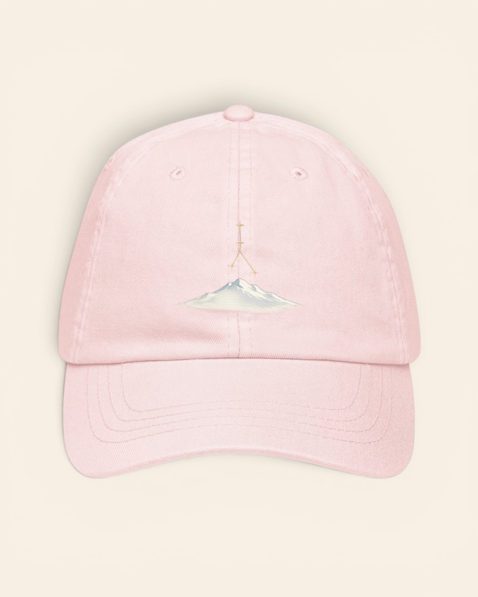 Cancer constellation hat with embroidered stars above a mountain ridge, in Pastel Pink