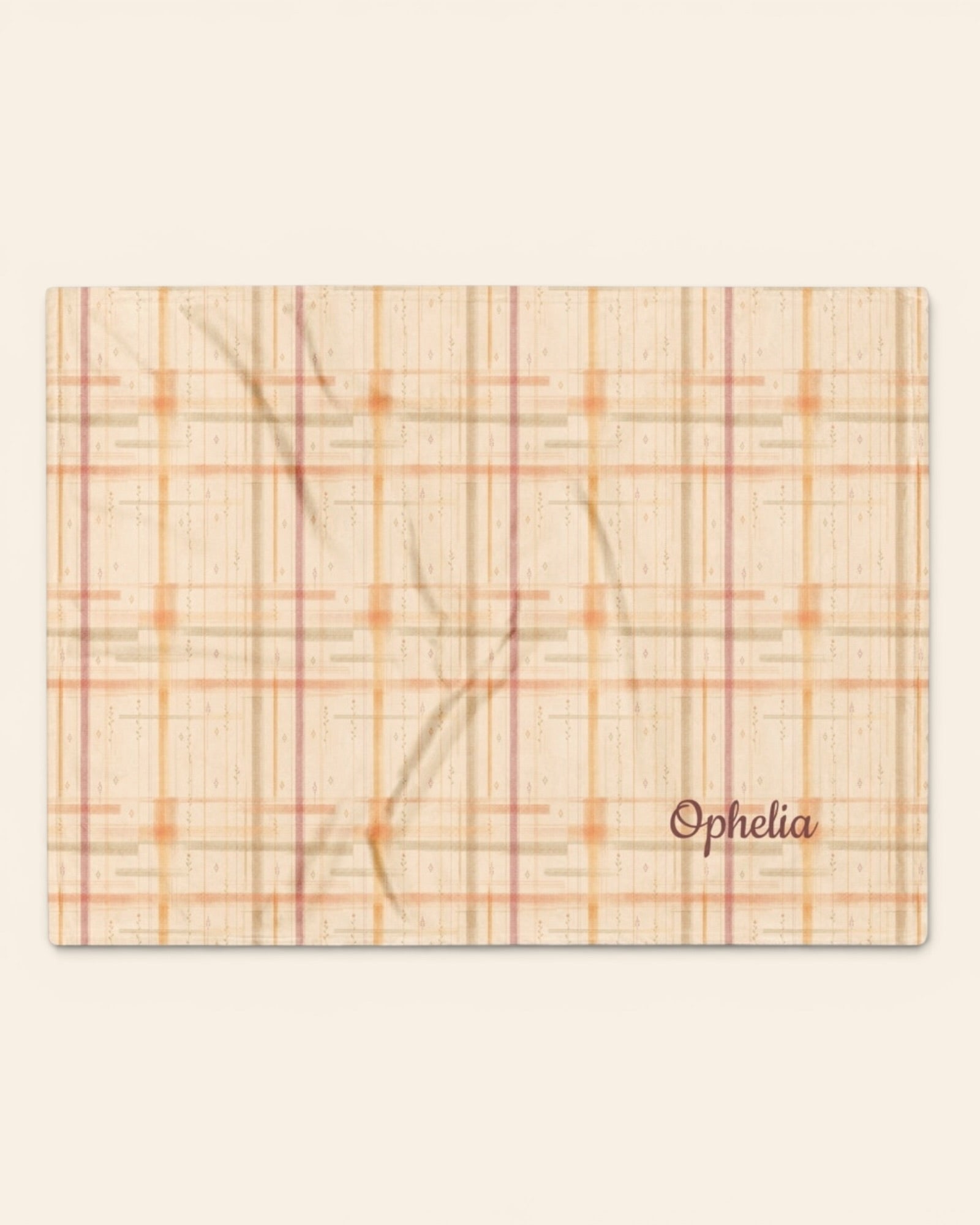Written By The Wilderness Throw Blanket, with vintage-inspired woven plaid in apricot, sage, and peach print
