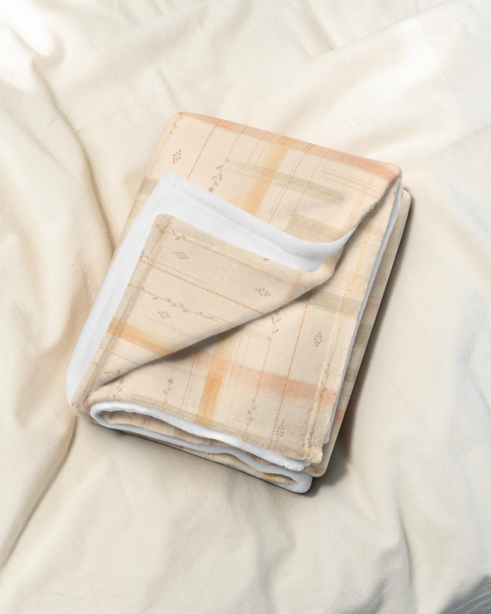 Written By The Wilderness Throw Blanket, with vintage-inspired woven plaid in apricot, sage, and peach print