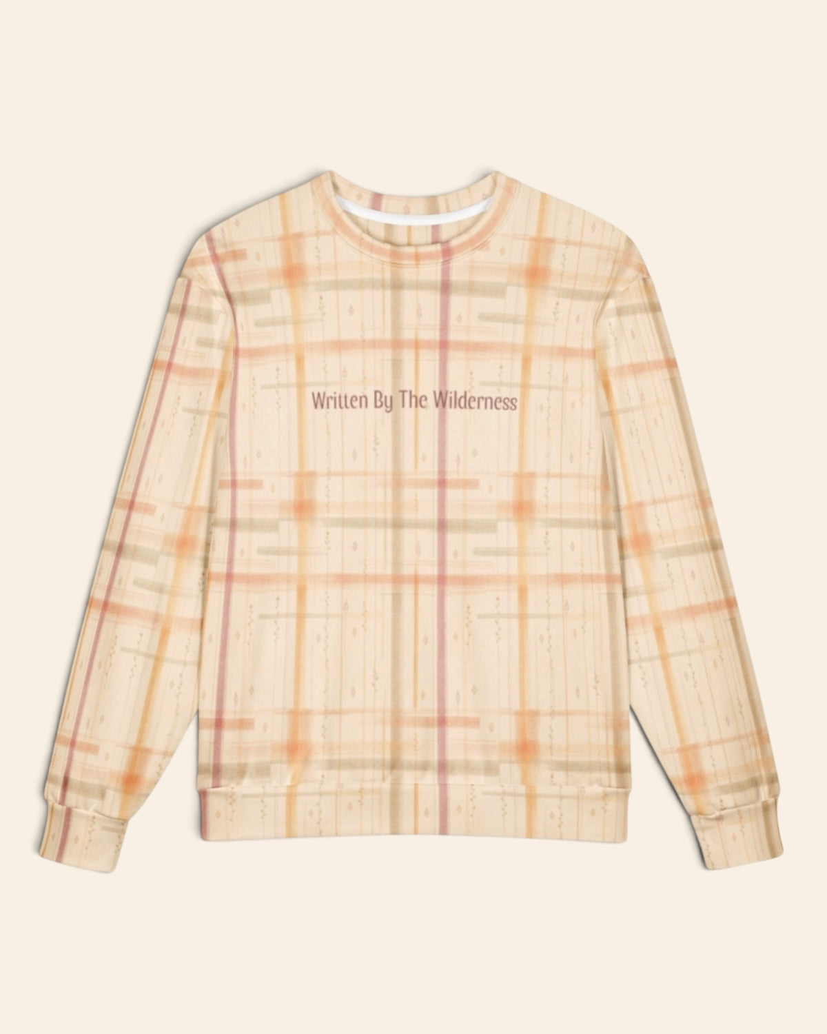 The oversized crewneck sweatshirt shown flat from the front on a plain cream background, sleeves out, cuffs and waistband ribbed. The all-over print is a cream plaid crossed by apricot, coral and rose lines, with the words Written By The Wilderness in a small script across the chest.