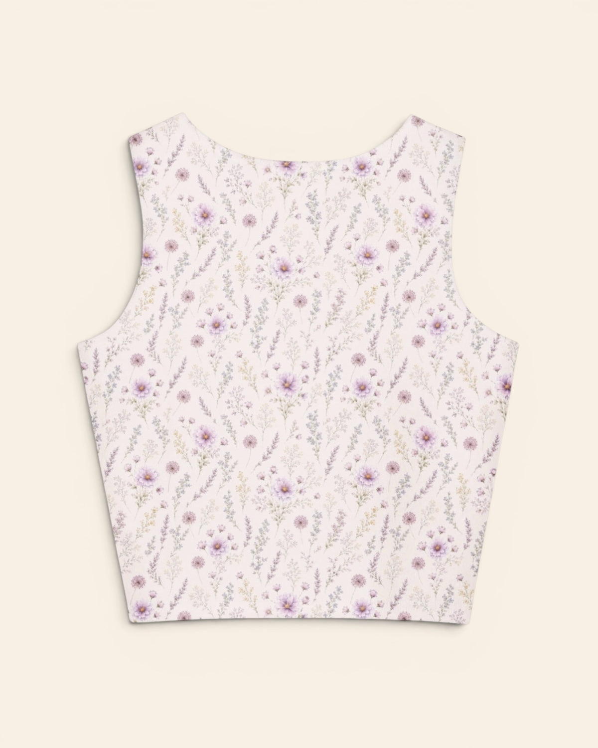 The same crop tank shown from the back on a plain cream background, with no text, so the print runs unbroken across the panel. It is white, printed with lavender and mauve wildflowers on slender stems.