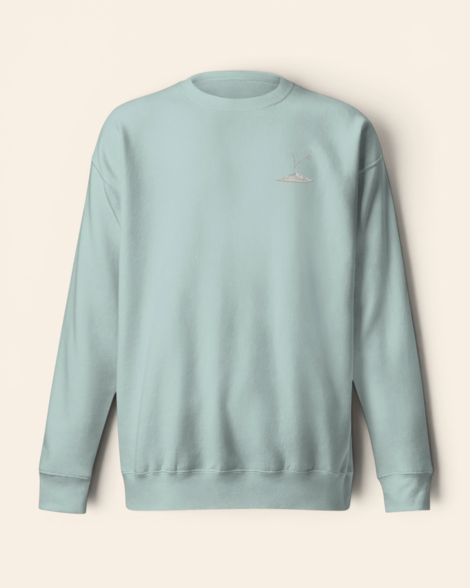 Pisces constellation crewneck sweatshirt with embroidered stars above a mountain ridge
