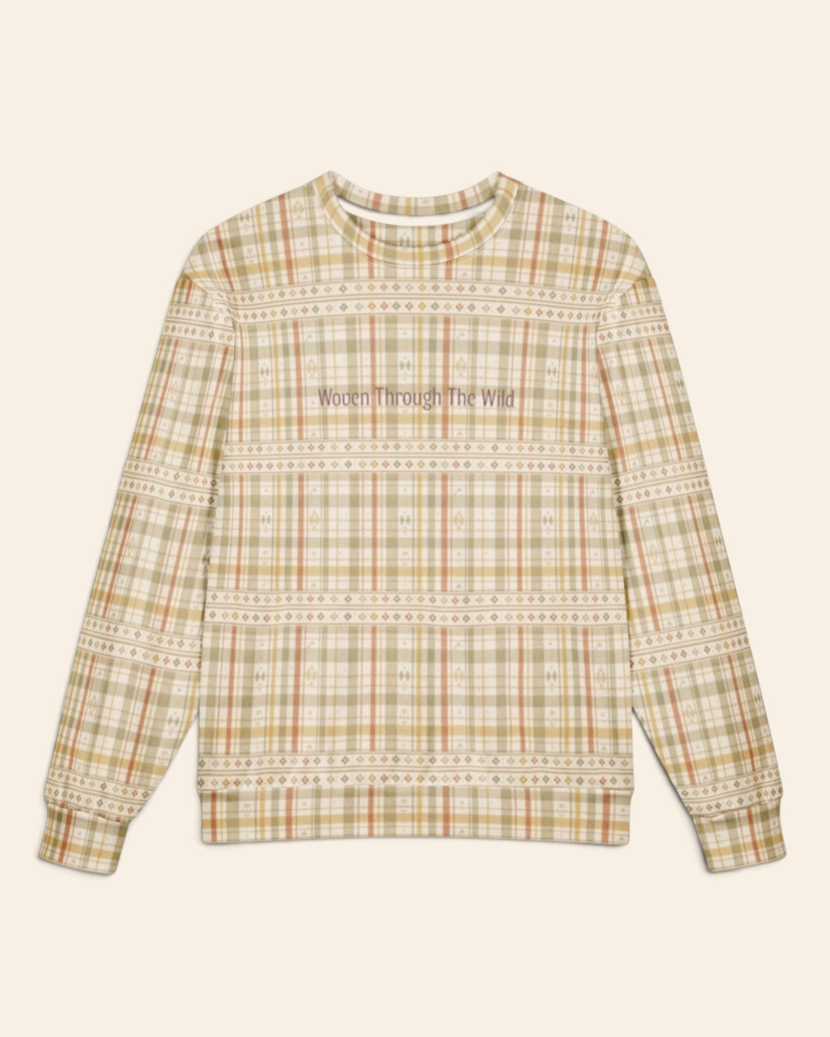 The oversized crewneck sweatshirt shown flat from the front on a plain cream background, sleeves out, cuffs and waistband ribbed. The all-over print is a sage, gold and apricot plaid on cream, banded with rows of small woven motifs, with the words Woven Through The Wild in a small script across the chest.
