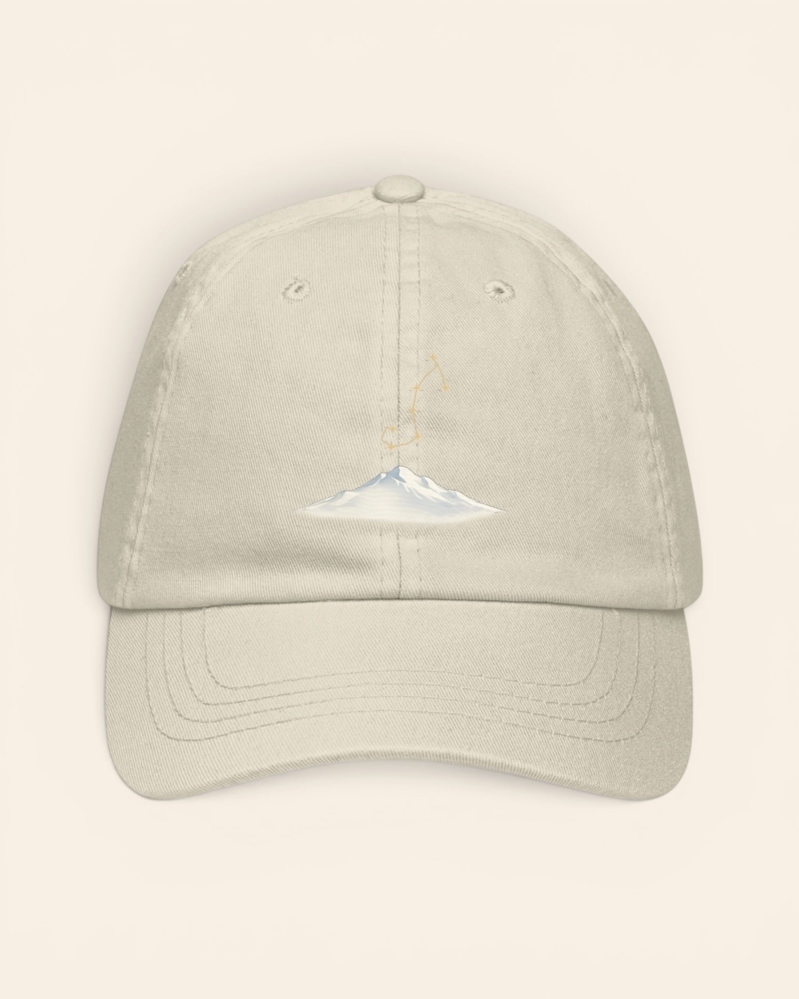 Scorpio constellation hat with embroidered stars above a mountain ridge, in Beige