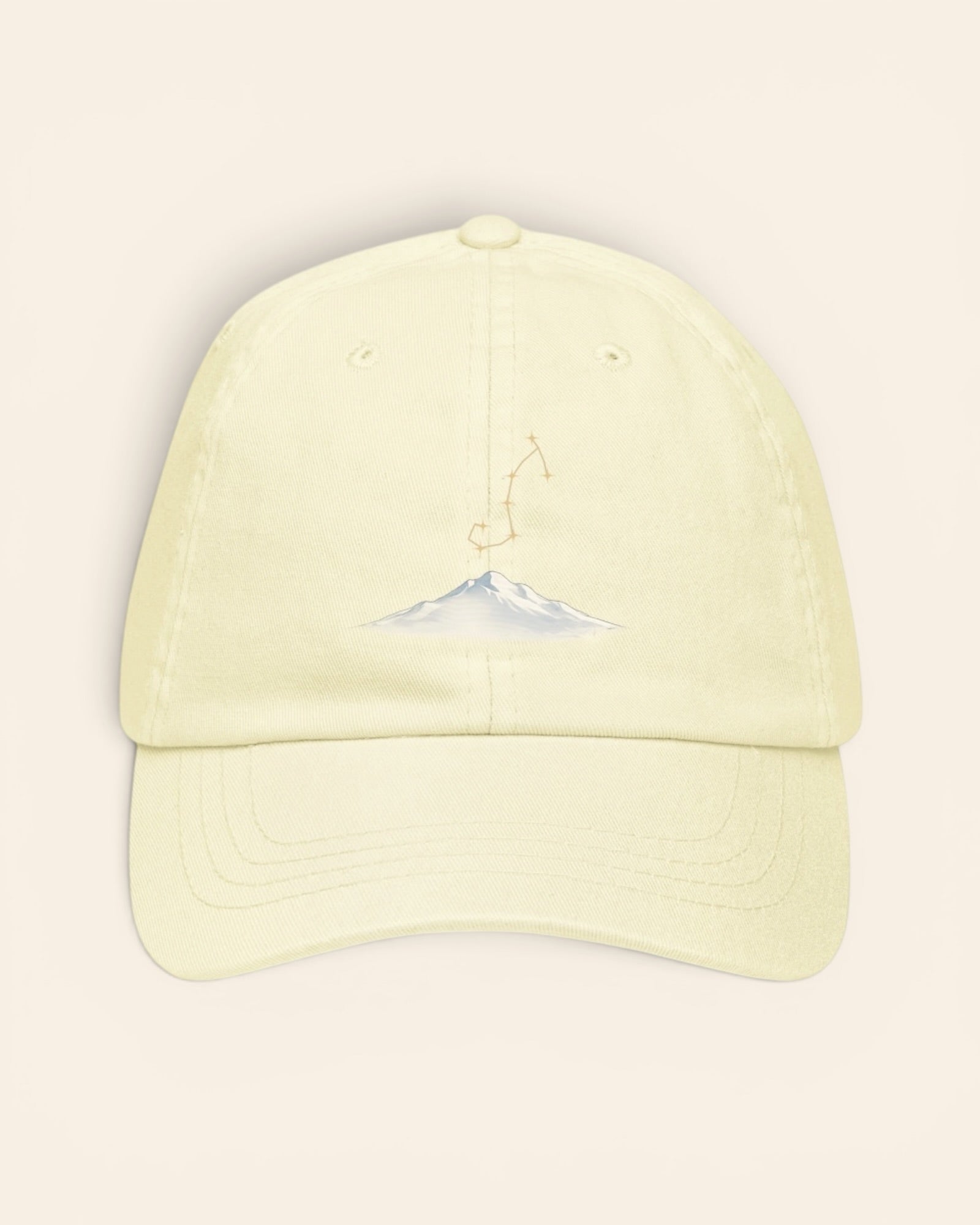 Scorpio constellation hat with embroidered stars above a mountain ridge, in Pastel Lemon