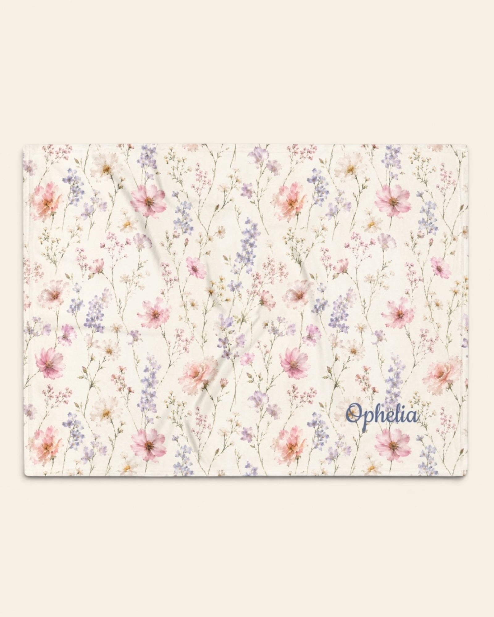 The Wildflower Theory Throw Blanket, with blush cosmos, cottage roses, larkspur, and baby's breath print