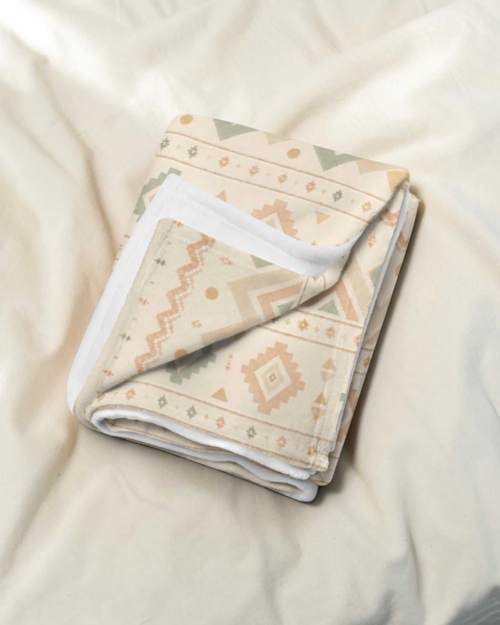 Where The Mountains Wait Throw Blanket, with mountain-inspired geometric bands in sage, sand, and peach print
