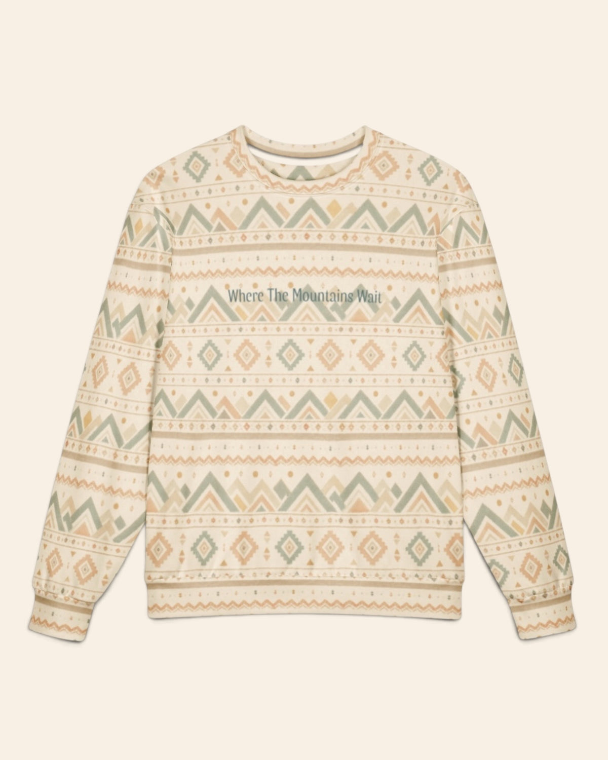 The oversized crewneck sweatshirt shown flat from the front on a plain cream background, sleeves out, cuffs and waistband ribbed. The all-over print is cream, banded with sage and gold chevrons, diamonds and small geometric motifs, with the words Where The Mountains Wait in a small script across the chest.