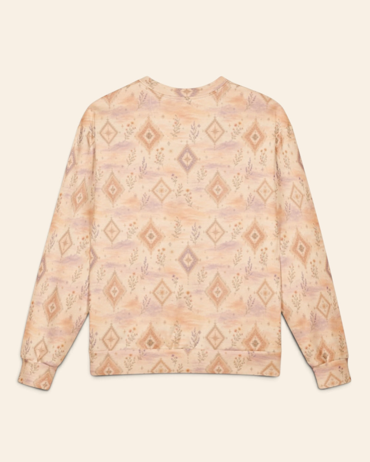 The same crewneck shown flat from the back on a plain cream background, with no text, so the all-over print runs unbroken across the body and sleeves. It is a peach and apricot wash set with cream diamond medallions and fine wildflower sprigs.
