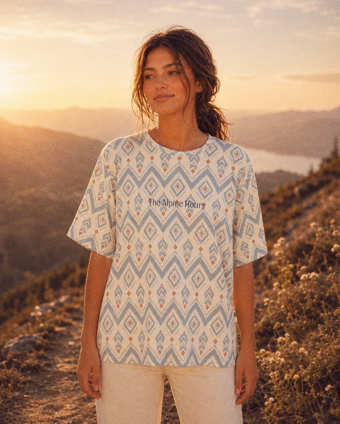 The Alpine Hours Oversized Tee, with mountain-inspired diamonds and rust accents print