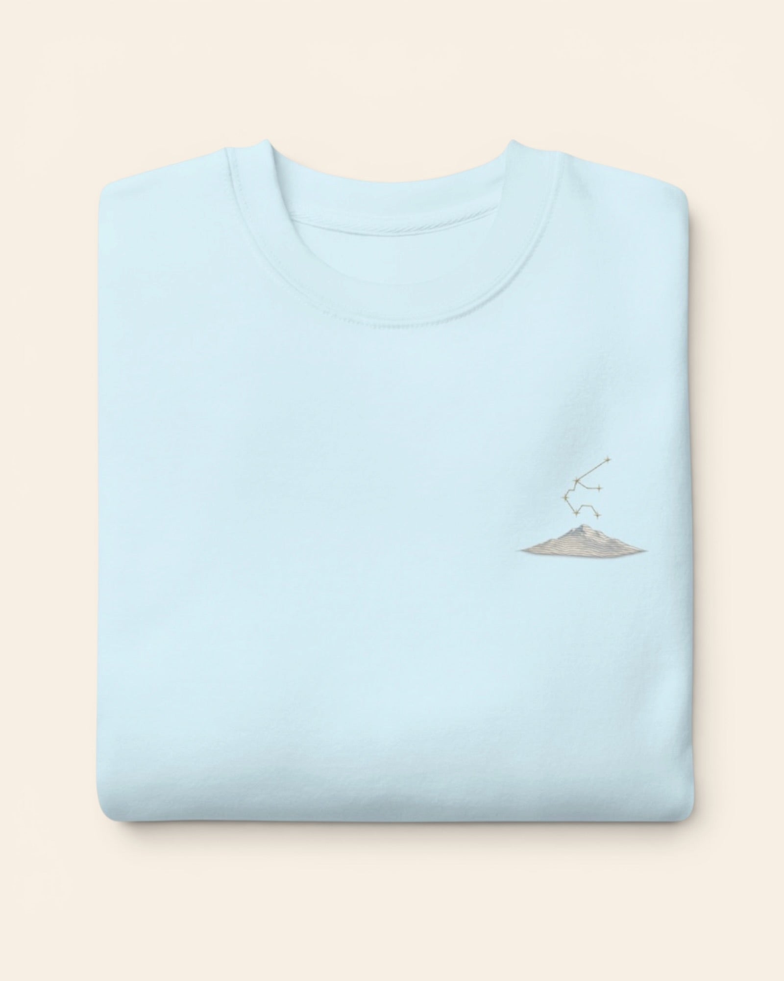Aquarius constellation crewneck sweatshirt with embroidered stars above a mountain ridge, in Sky Blue