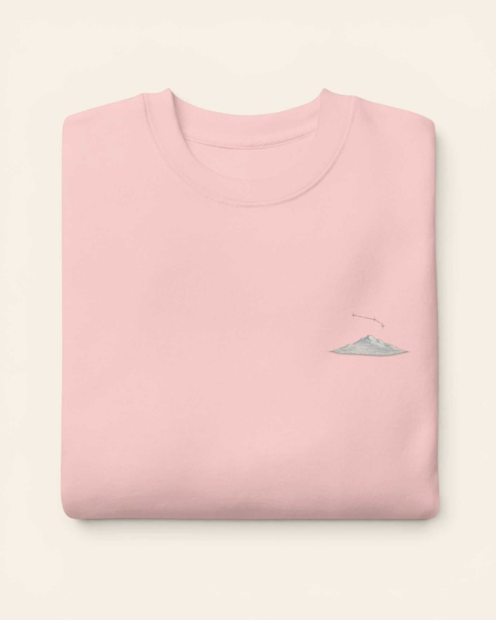 Aries constellation crewneck sweatshirt with embroidered stars above a mountain ridge, in Light Pink
