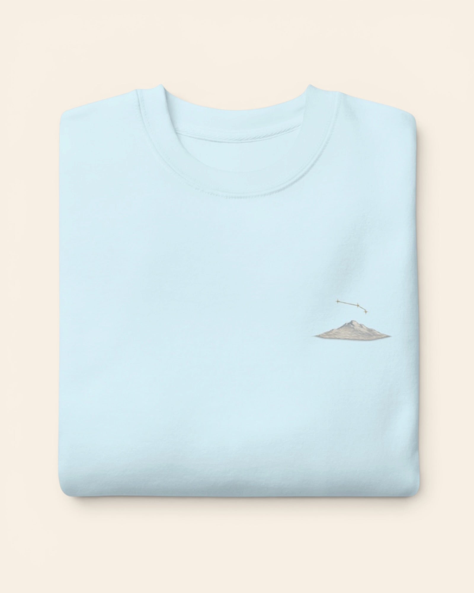Aries constellation crewneck sweatshirt with embroidered stars above a mountain ridge, in Sky Blue