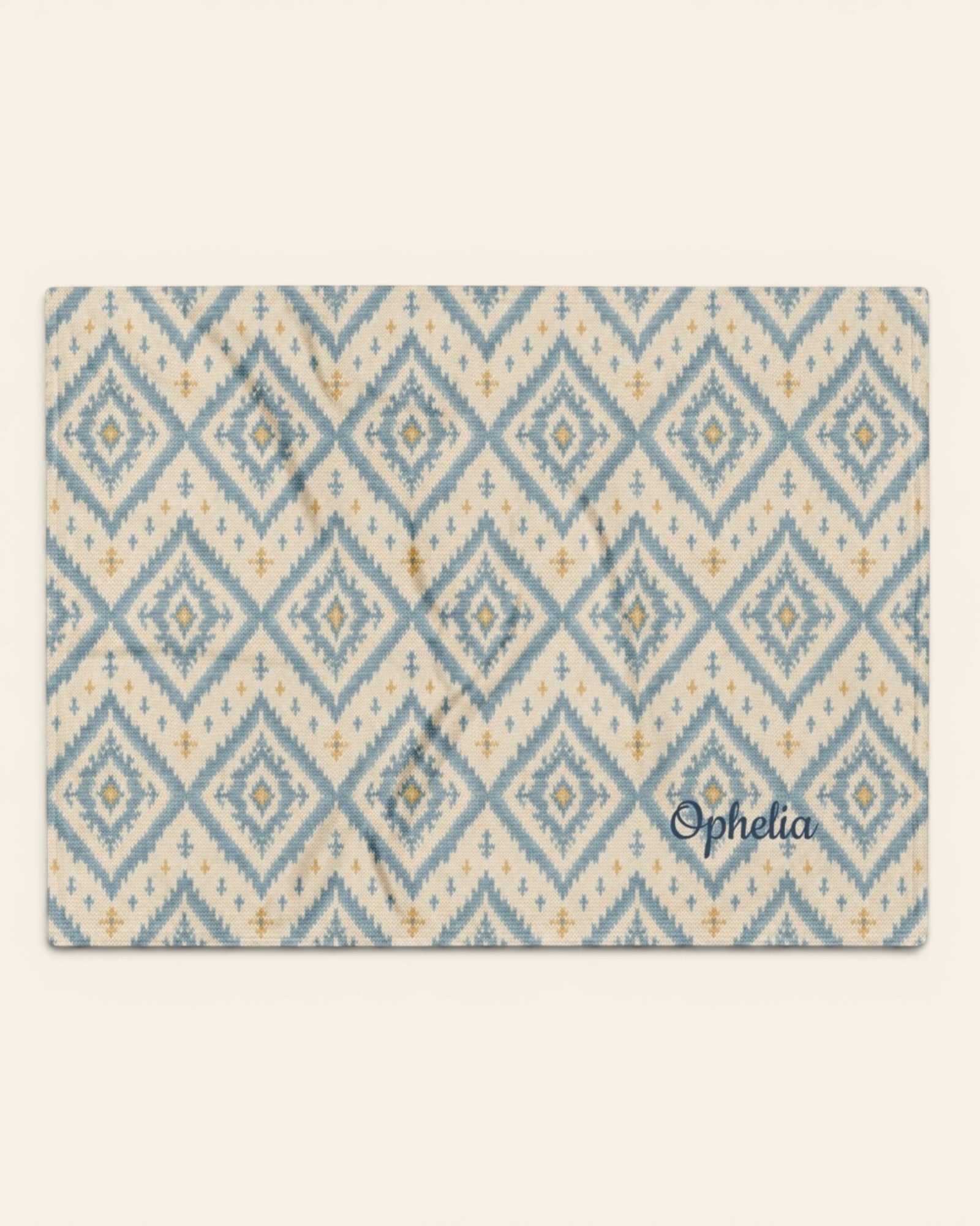A Place Between The Peaks Throw Blanket, with dusty blue ikat-inspired diamonds and soft golden accents print