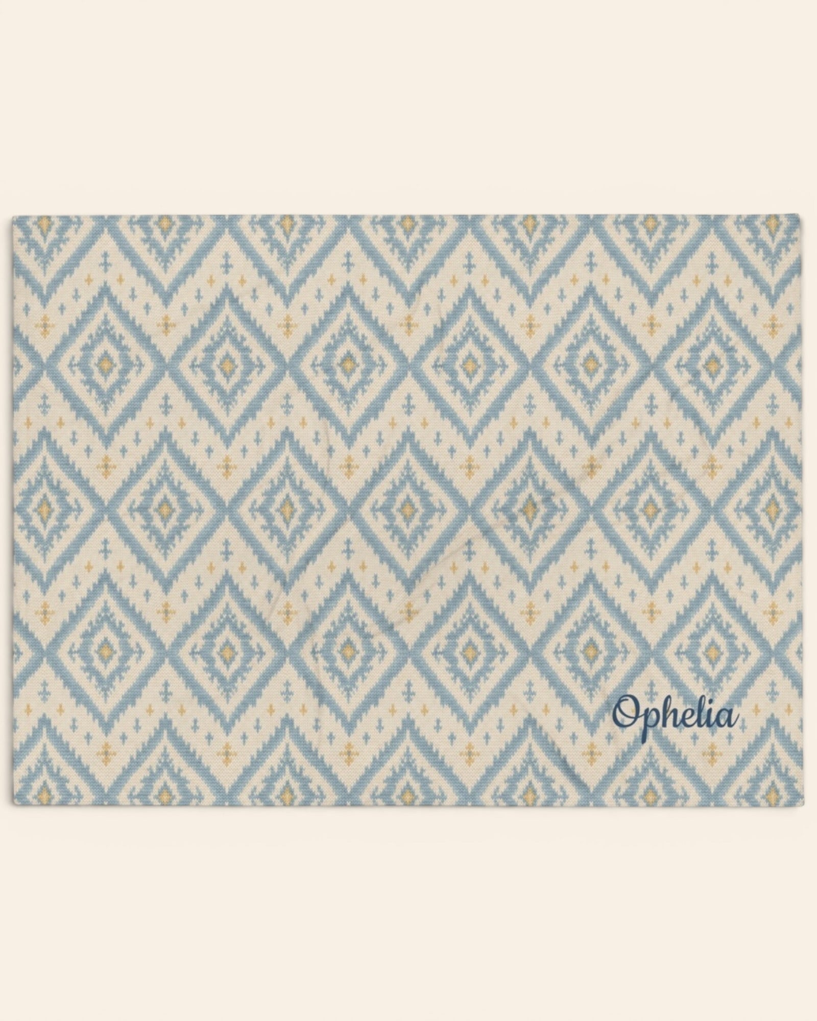 A Place Between The Peaks Throw Blanket, with dusty blue ikat-inspired diamonds and soft golden accents print