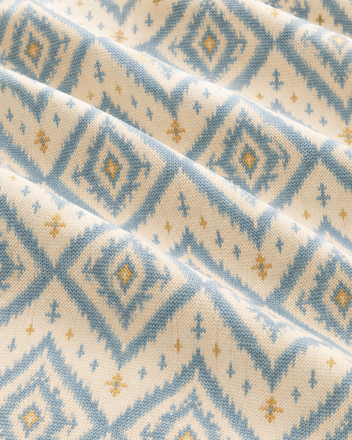 A Place Between The Peaks Crop Top, with dusty blue ikat-inspired diamonds and soft golden accents print