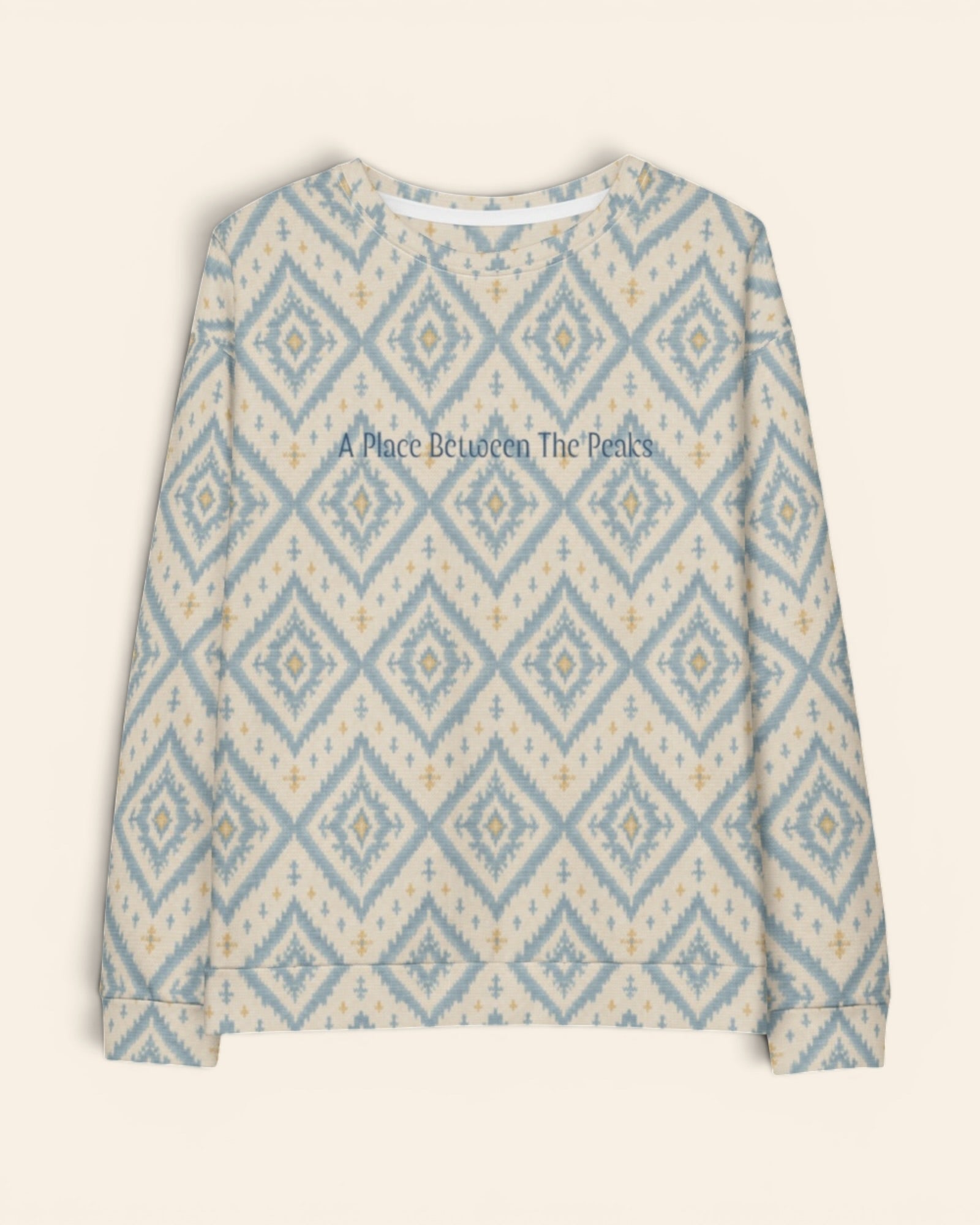 A Place Between The Peaks Crewneck Sweatshirt, with dusty blue ikat-inspired diamonds and soft golden accents print