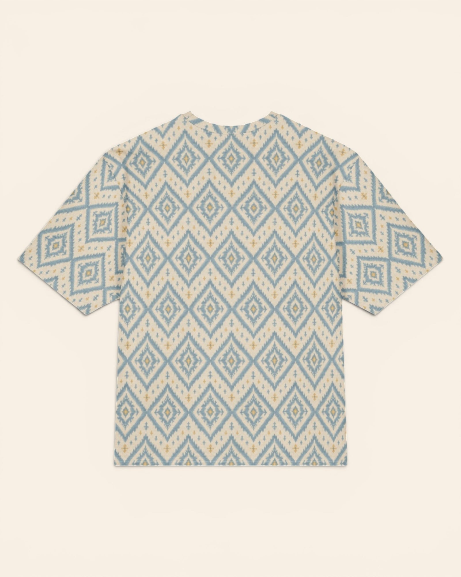 A Place Between The Peaks Oversized Tee, with dusty blue ikat-inspired diamonds and soft golden accents print