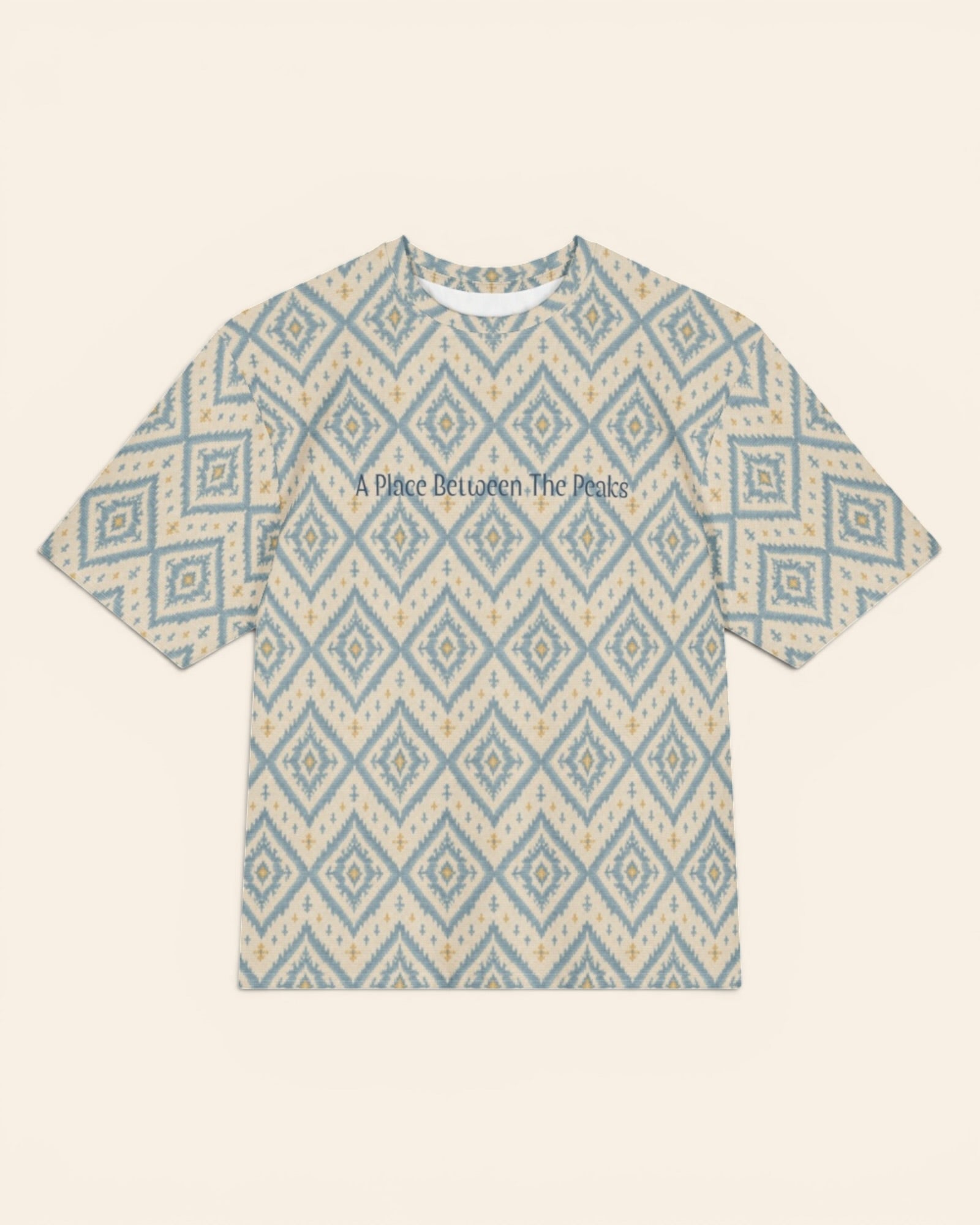 A Place Between The Peaks Oversized Tee, with dusty blue ikat-inspired diamonds and soft golden accents print