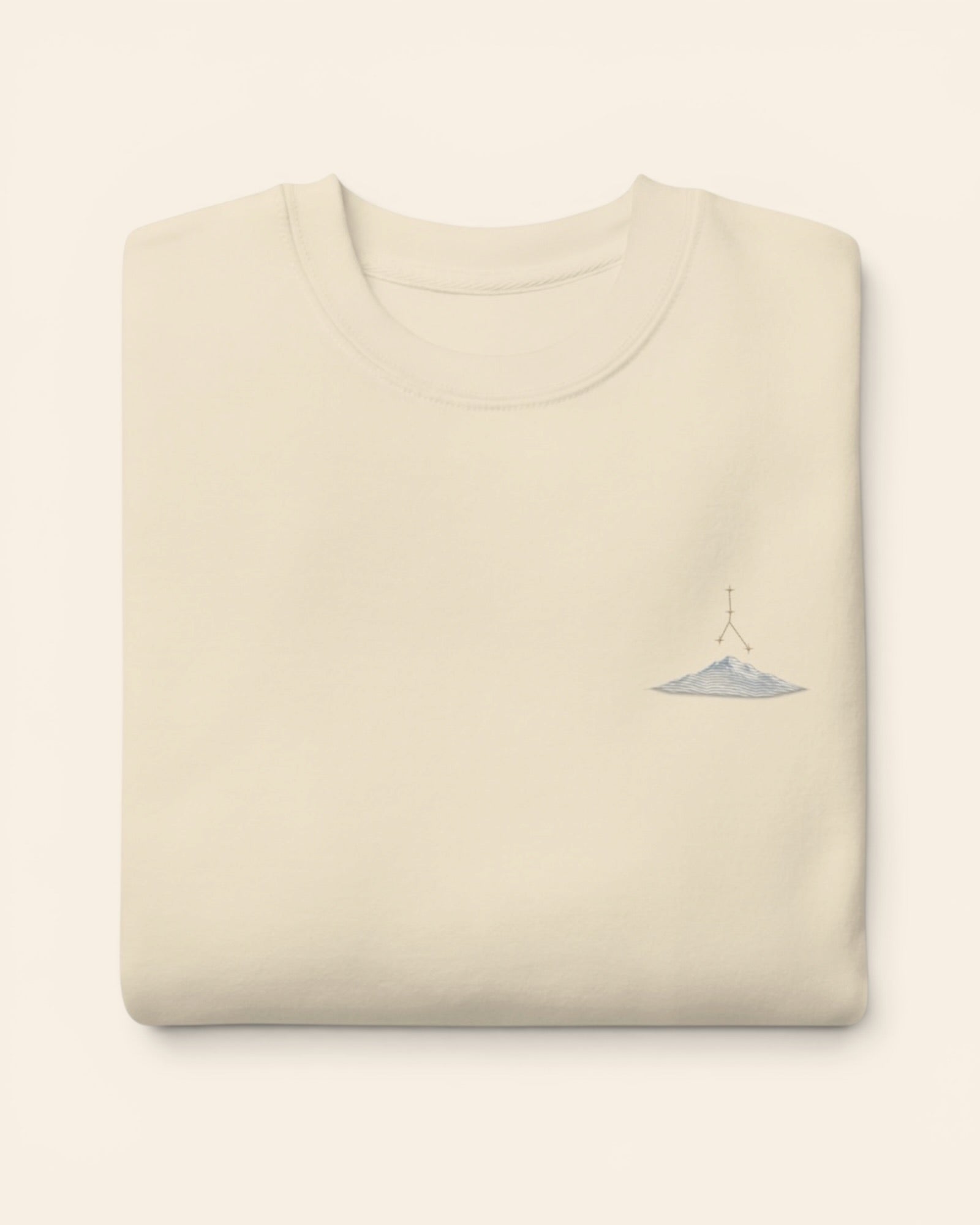 Cancer constellation crewneck sweatshirt with embroidered stars above a mountain ridge, in Bone