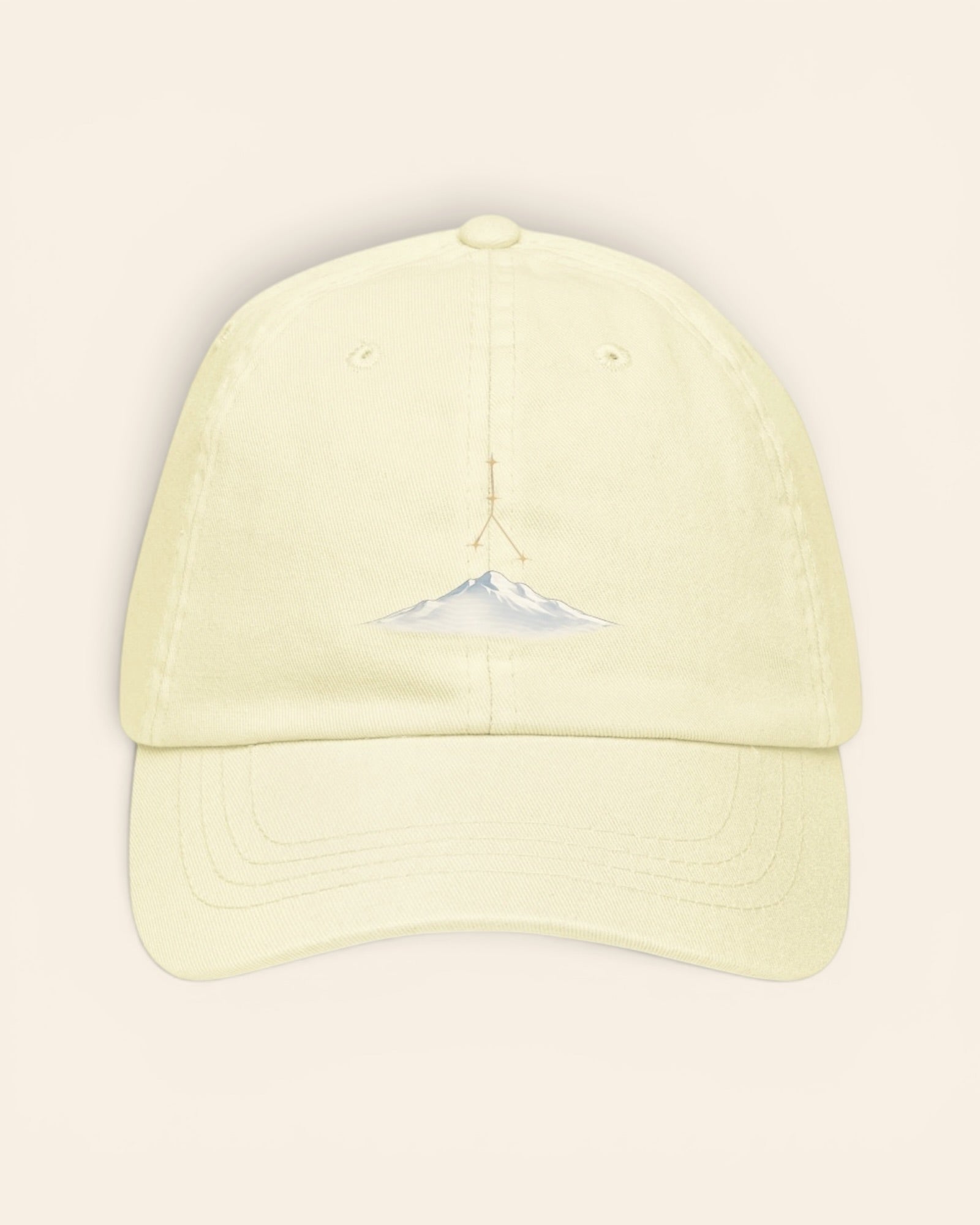 Cancer constellation hat with embroidered stars above a mountain ridge, in Pastel Lemon
