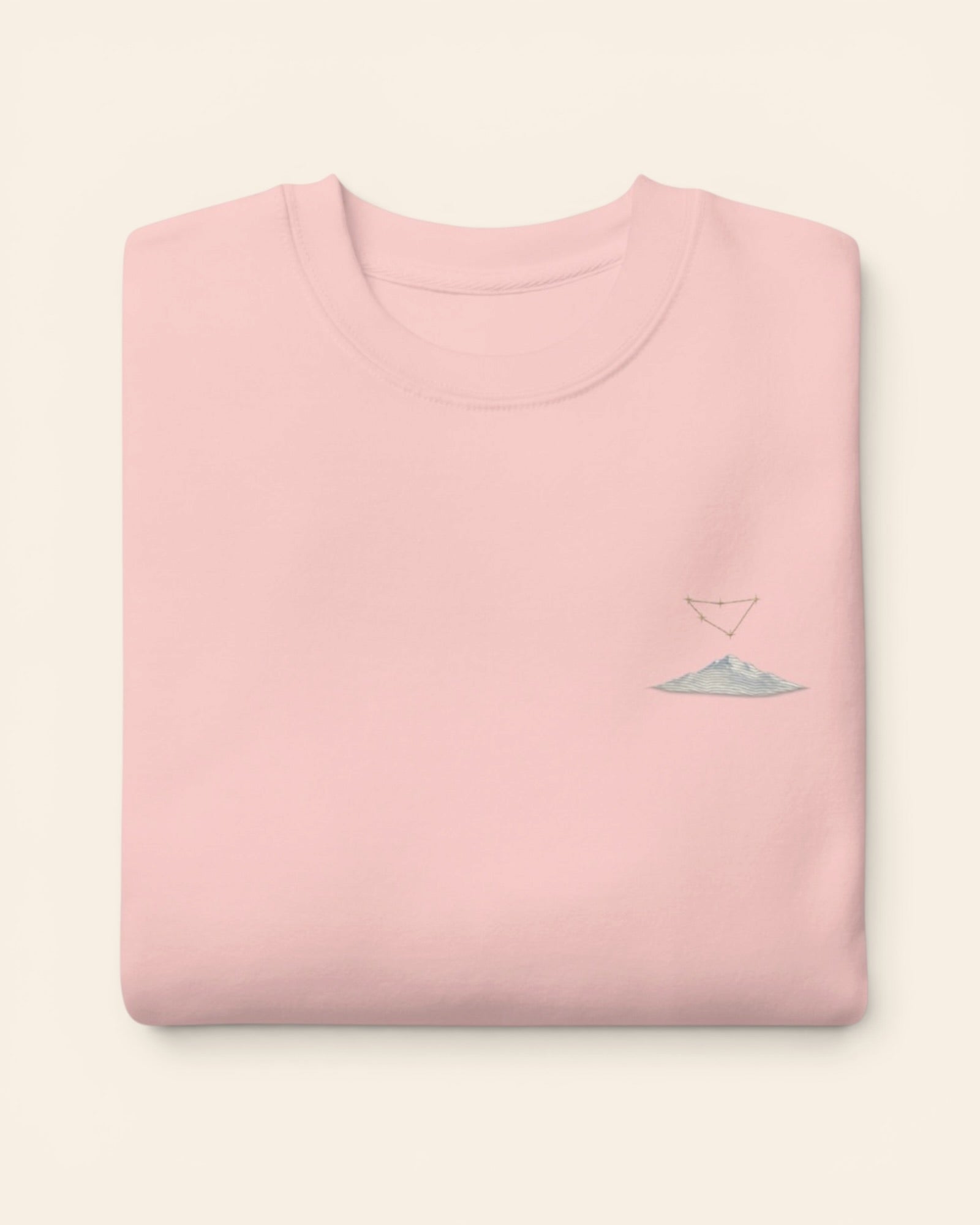 Capricorn constellation crewneck sweatshirt with embroidered stars above a mountain ridge, in Light Pink