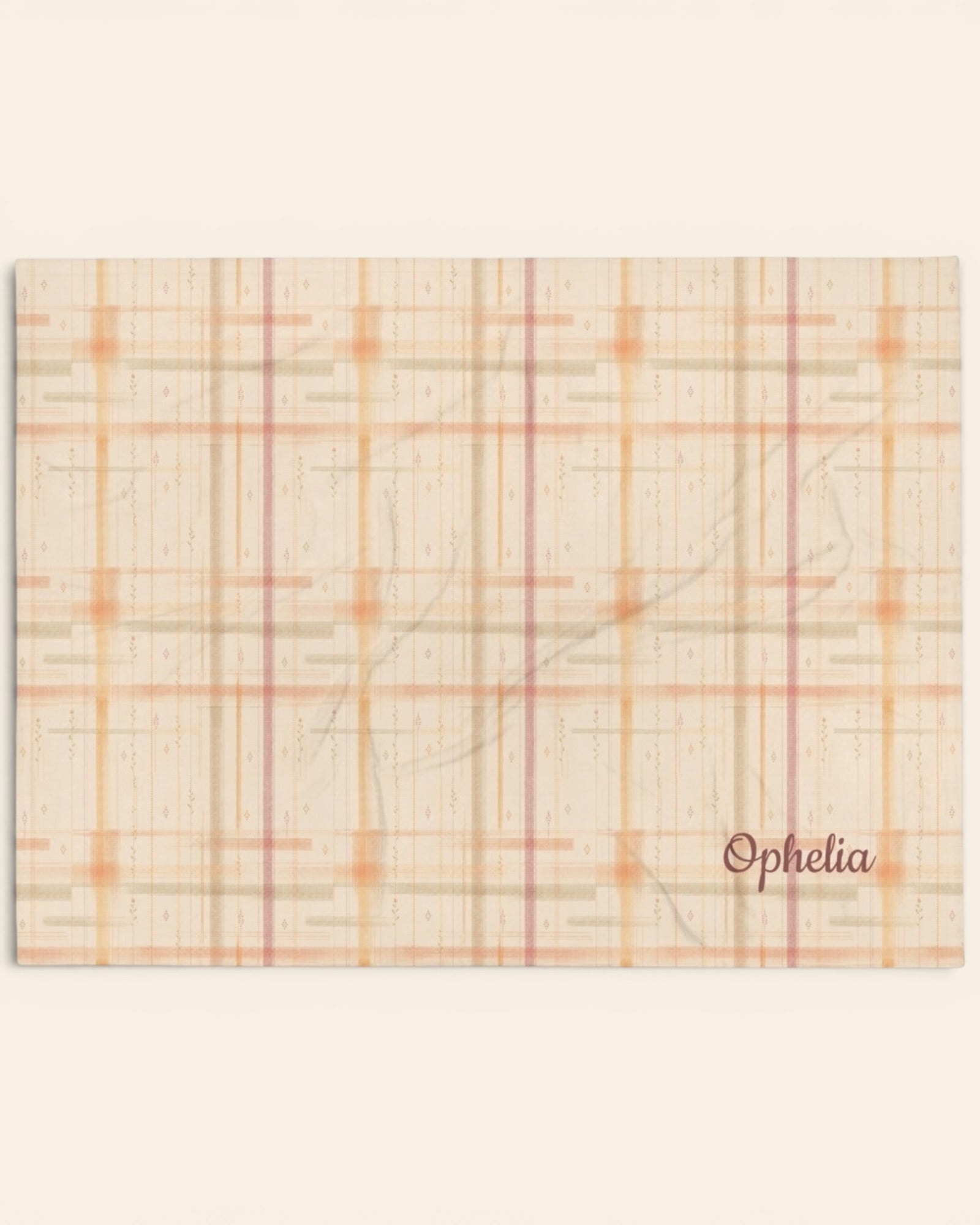 Written By The Wilderness Throw Blanket, with vintage-inspired woven plaid in apricot, sage, and peach print