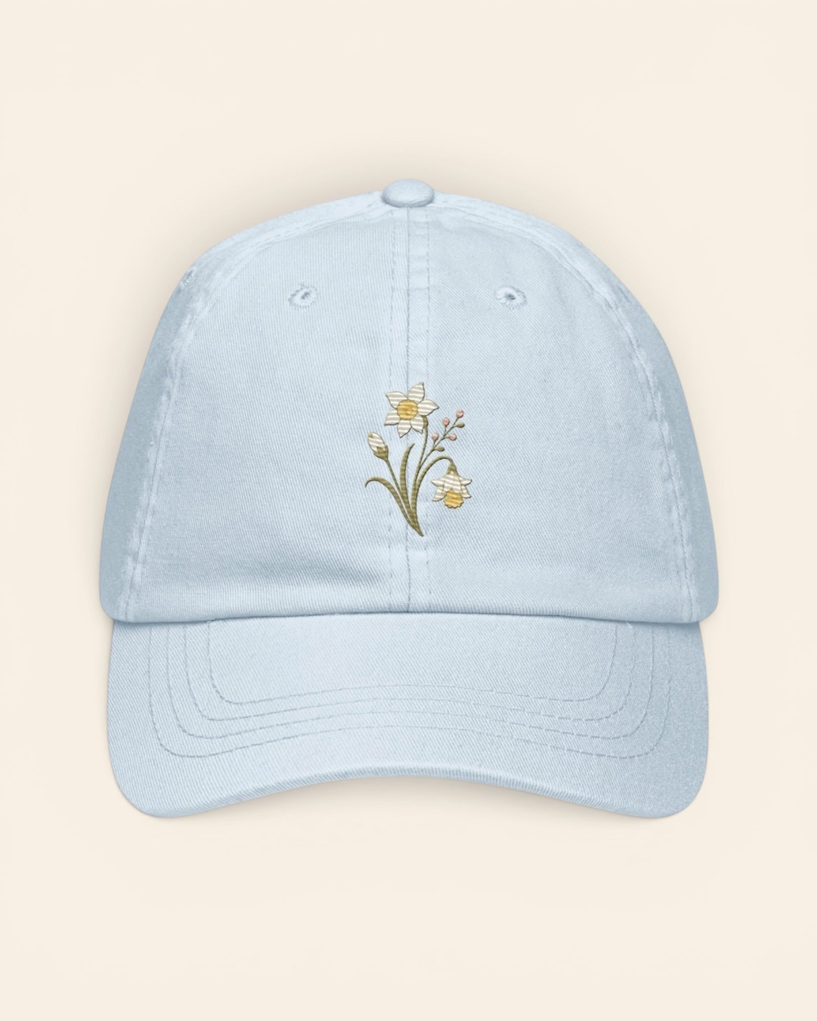 December birth flower hat with embroidered narcissus and holly, in Pastel Blue