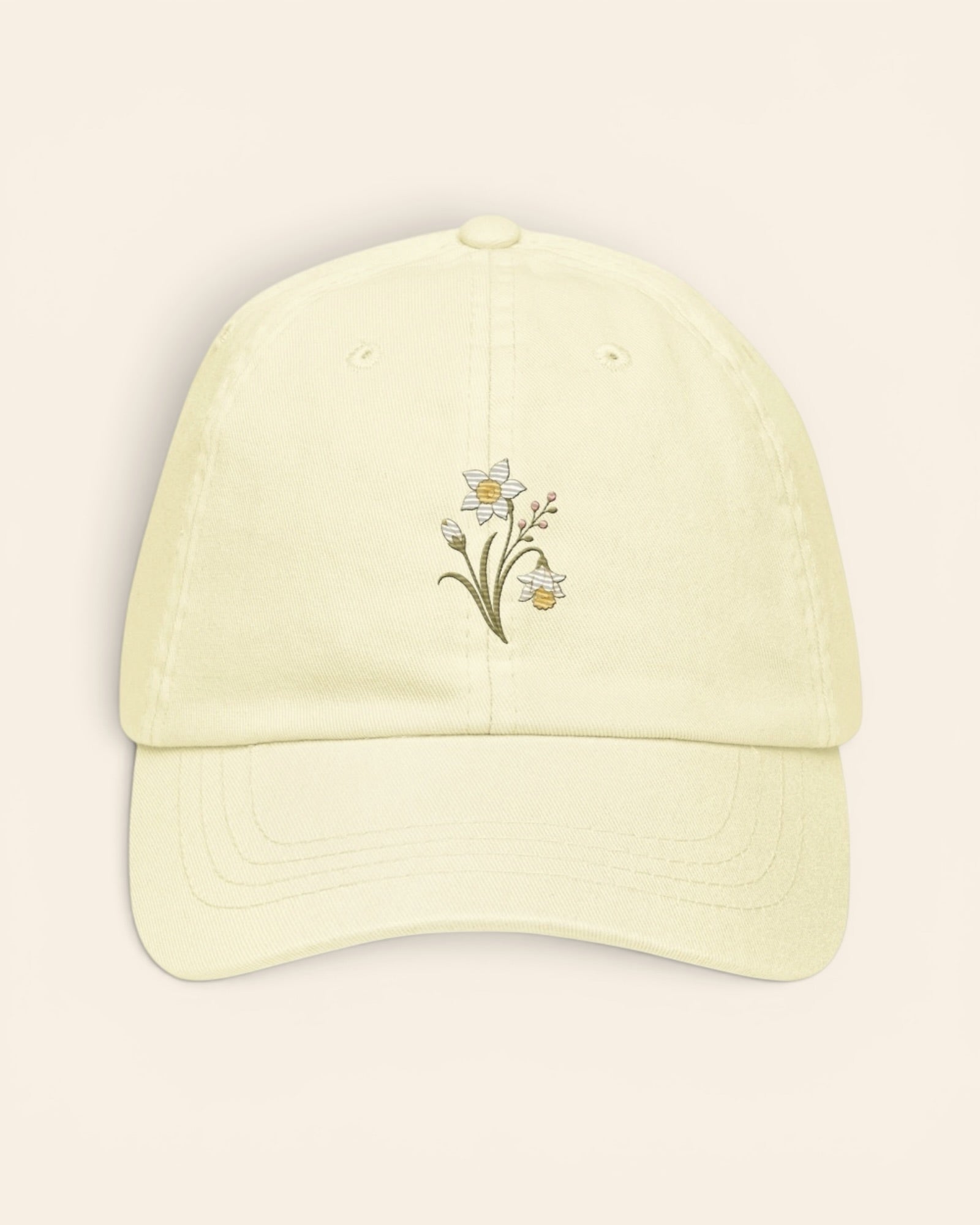 December birth flower hat with embroidered narcissus and holly, in Pastel Lemon