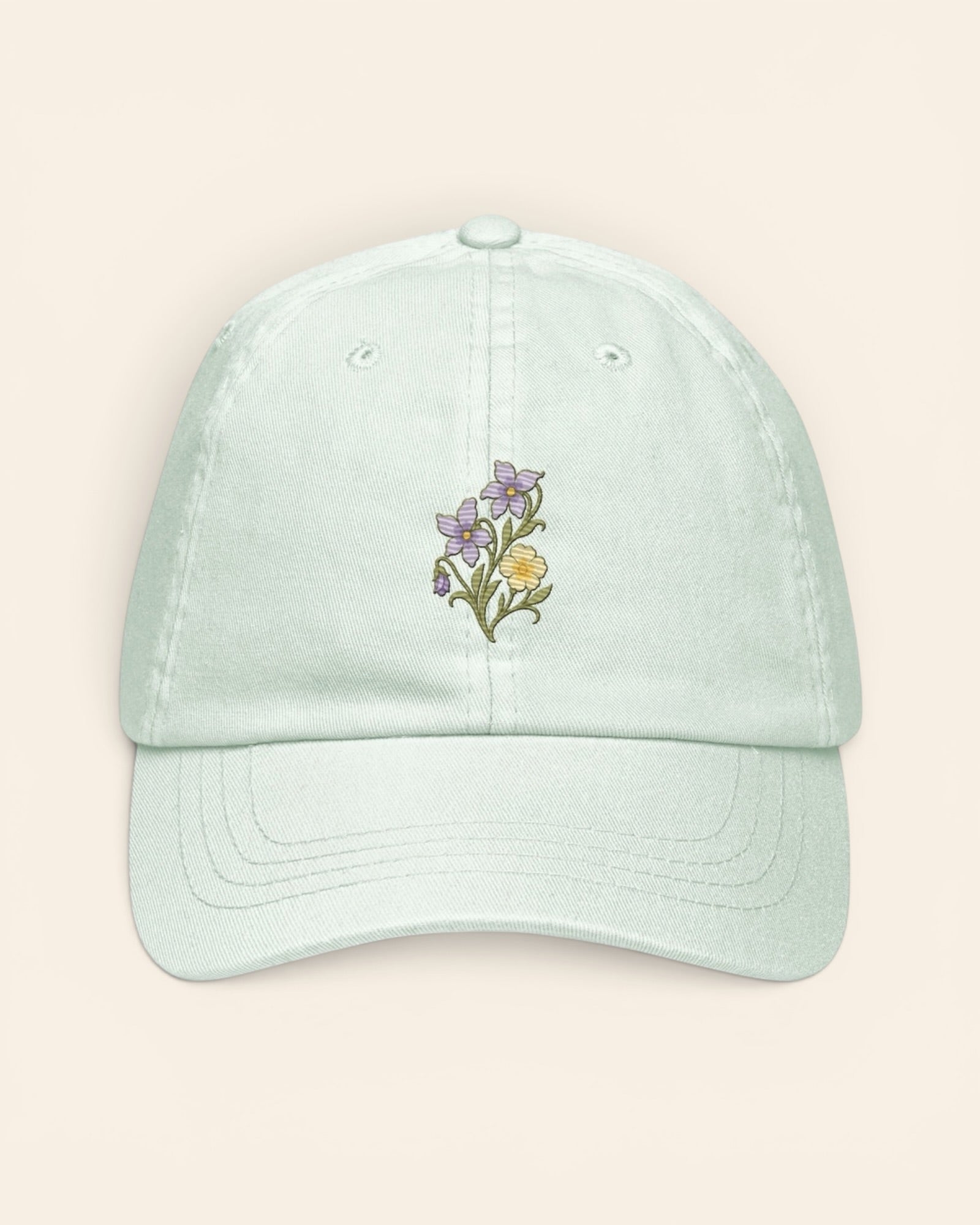 February birth flower hat with embroidered violet and primrose, in Pastel Mint