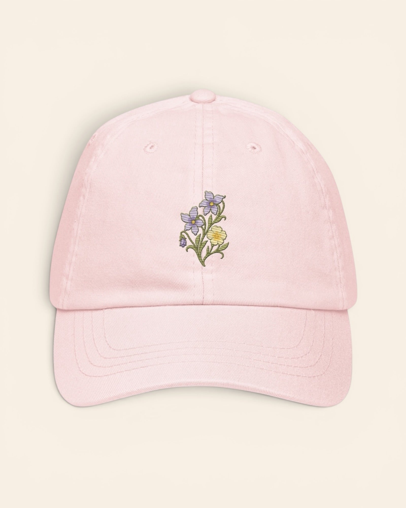 February birth flower hat with embroidered violet and primrose, in Pastel Pink