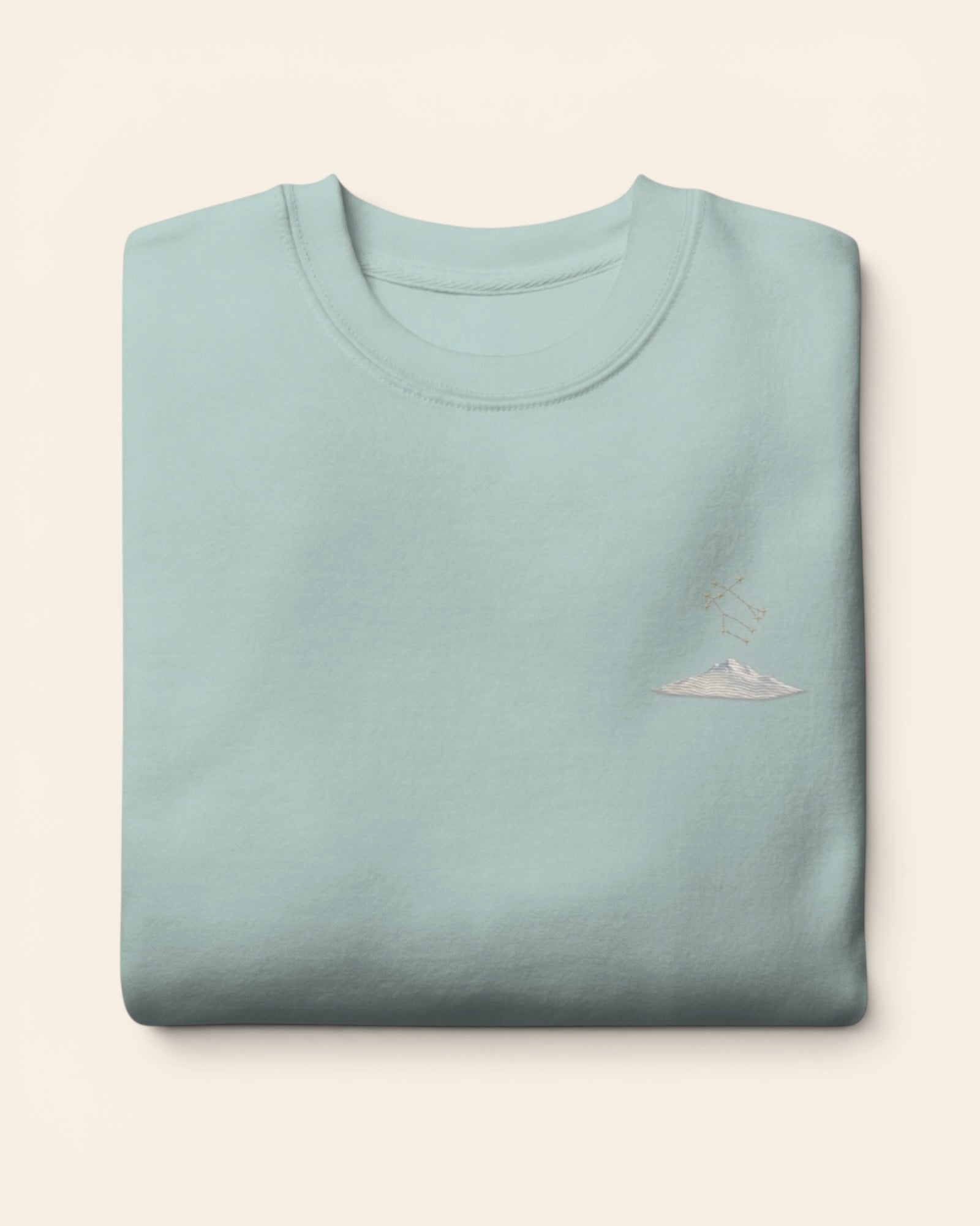 Gemini constellation crewneck sweatshirt with embroidered stars above a mountain ridge, in Agave