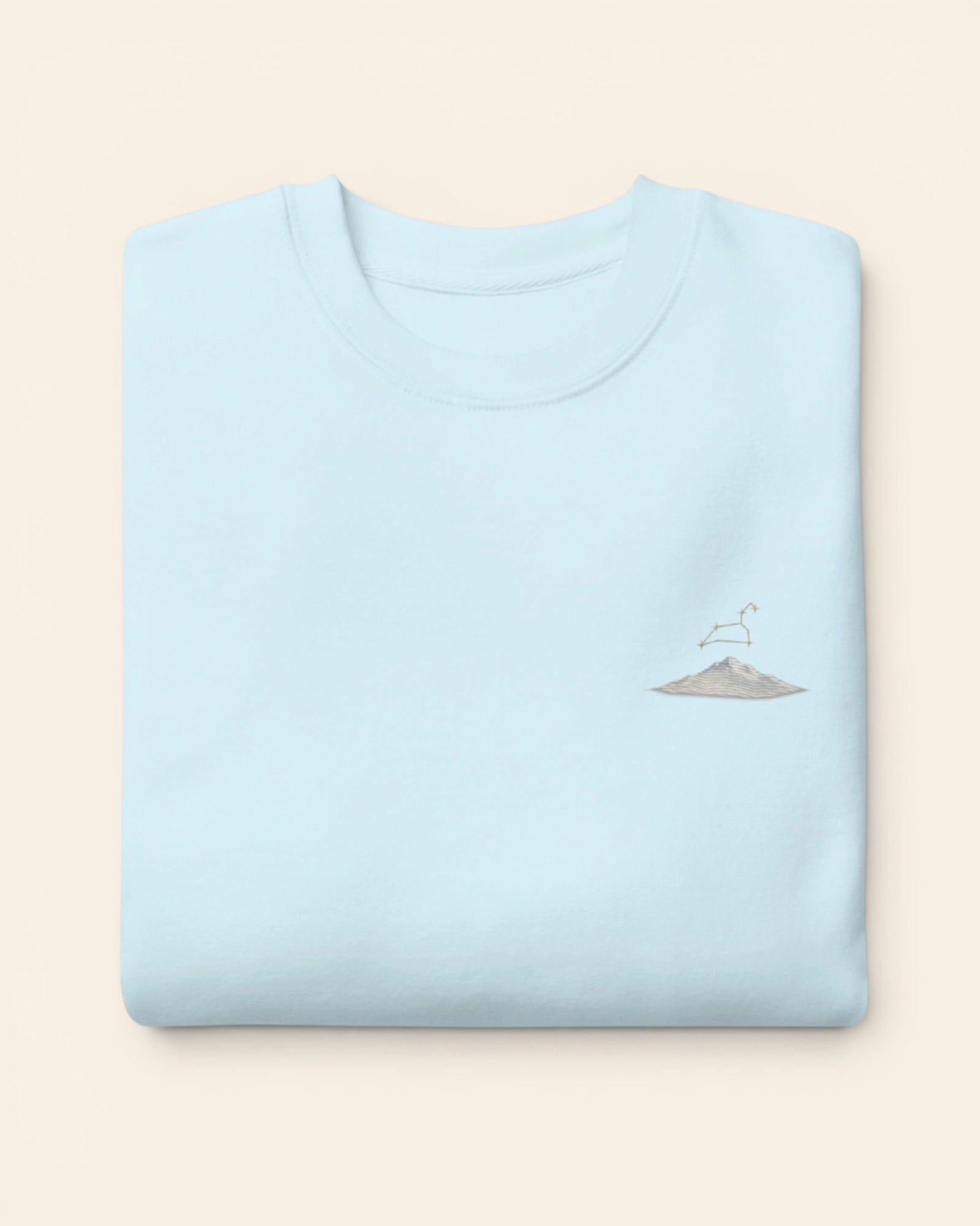 Leo constellation crewneck sweatshirt with embroidered stars above a mountain ridge, in Sky Blue