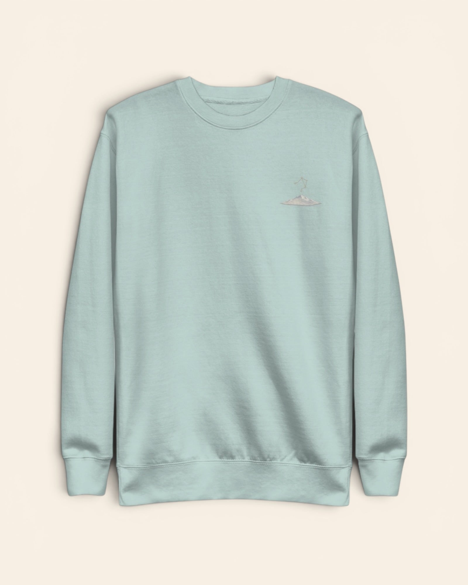 Libra constellation crewneck sweatshirt with embroidered stars above a mountain ridge