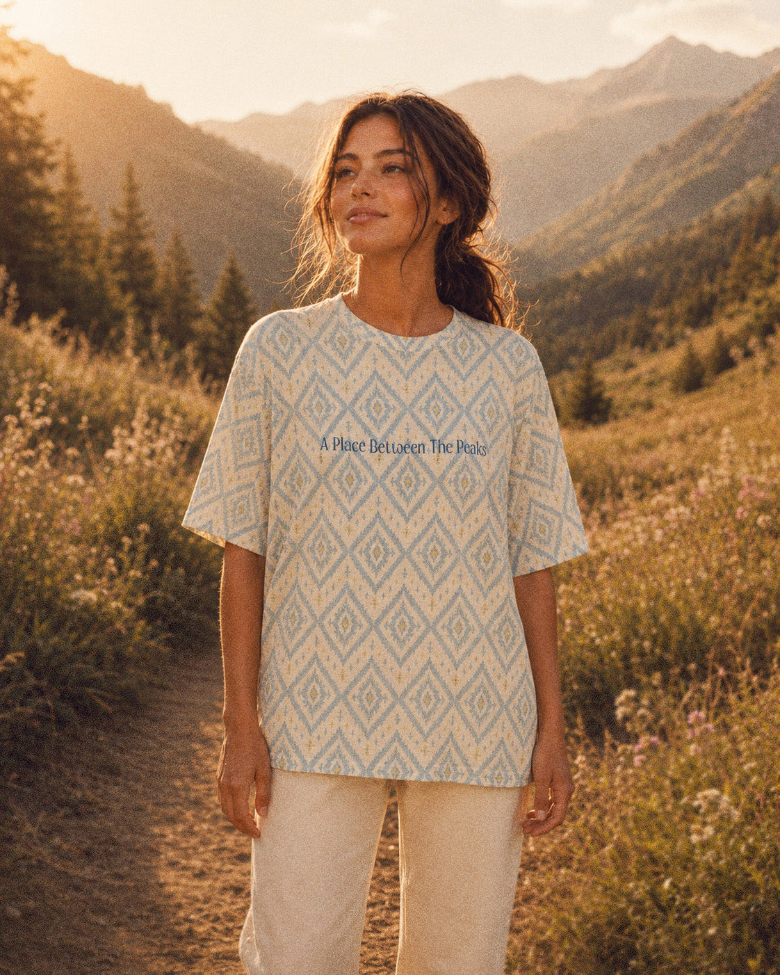 A Place Between The Peaks Oversized Tee, with dusty blue ikat-inspired diamonds and soft golden accents print