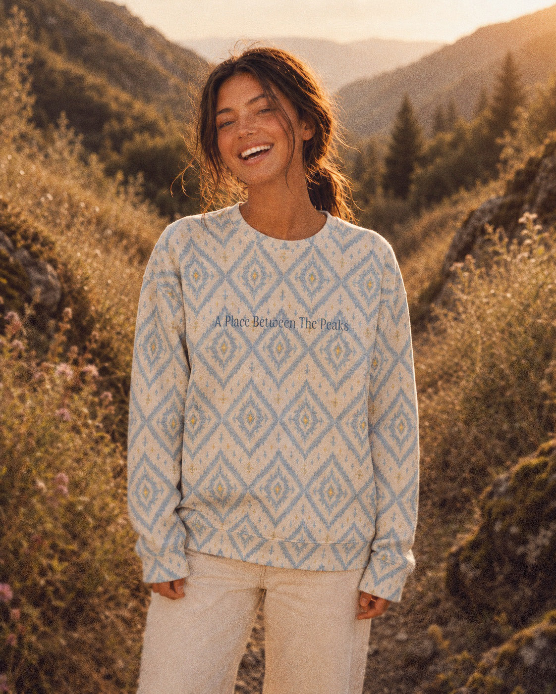 A Place Between The Peaks Crewneck Sweatshirt, with dusty blue ikat-inspired diamonds and soft golden accents print