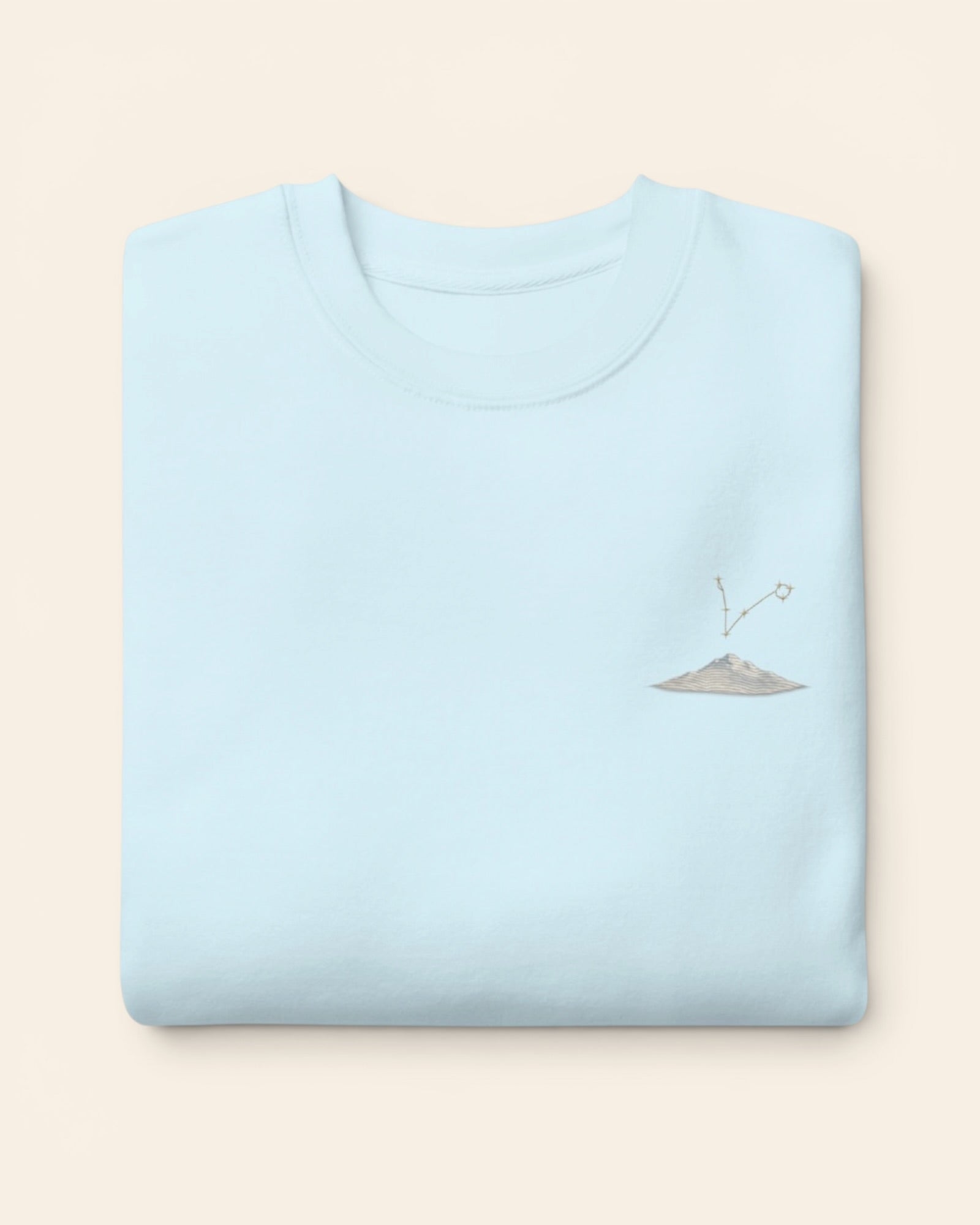 Pisces constellation crewneck sweatshirt with embroidered stars above a mountain ridge, in Sky Blue