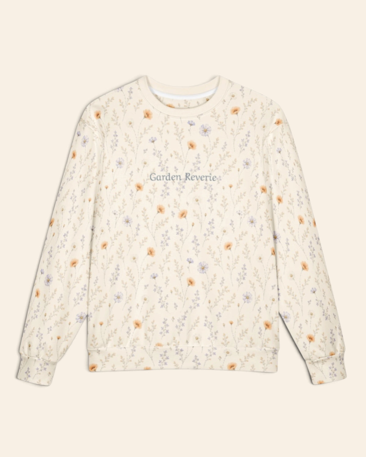 The oversized crewneck sweatshirt shown flat from the front on a plain cream background, sleeves out, cuffs and waistband ribbed. The all-over print is cream, scattered with small apricot poppies and lilac and periwinkle wildflowers on fine stems, with the words Garden Reverie in a small script across the chest.