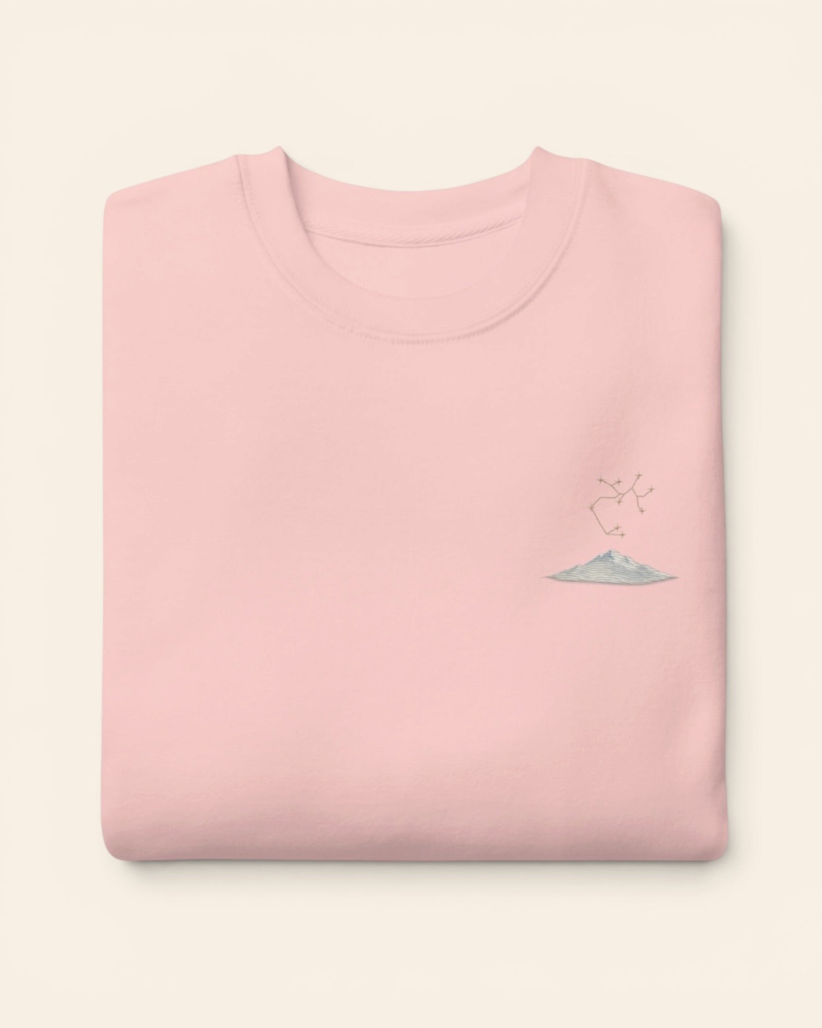 Sagittarius constellation crewneck sweatshirt with embroidered stars above a mountain ridge, in Light Pink