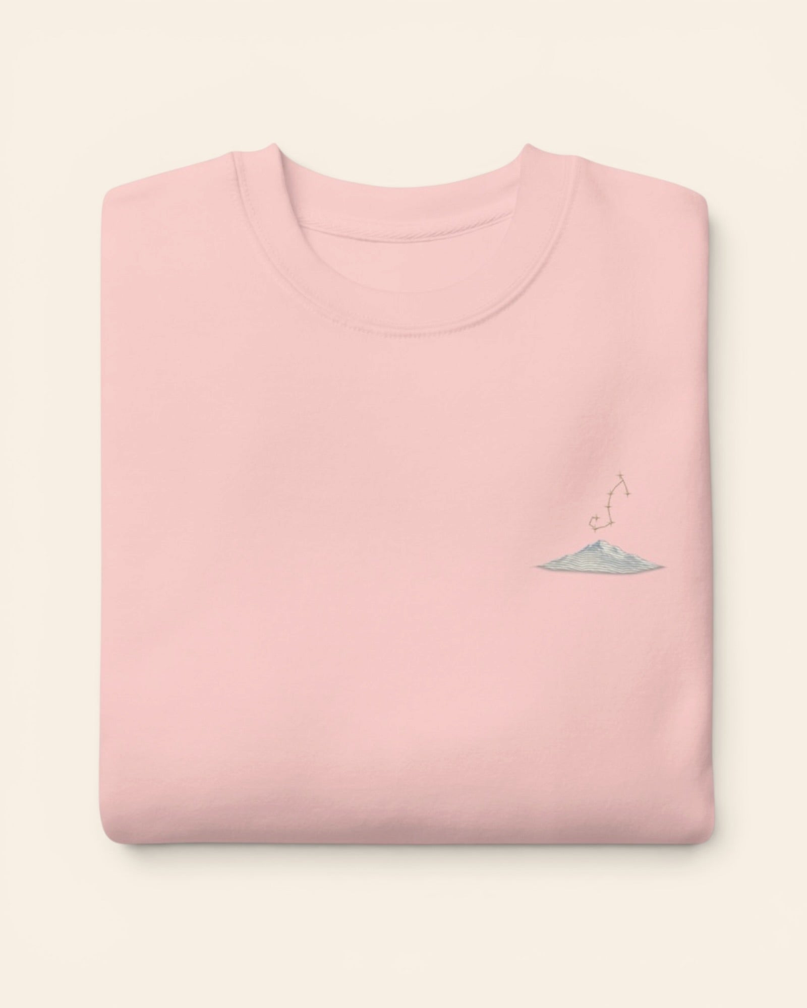 Scorpio constellation crewneck sweatshirt with embroidered stars above a mountain ridge, in Light Pink