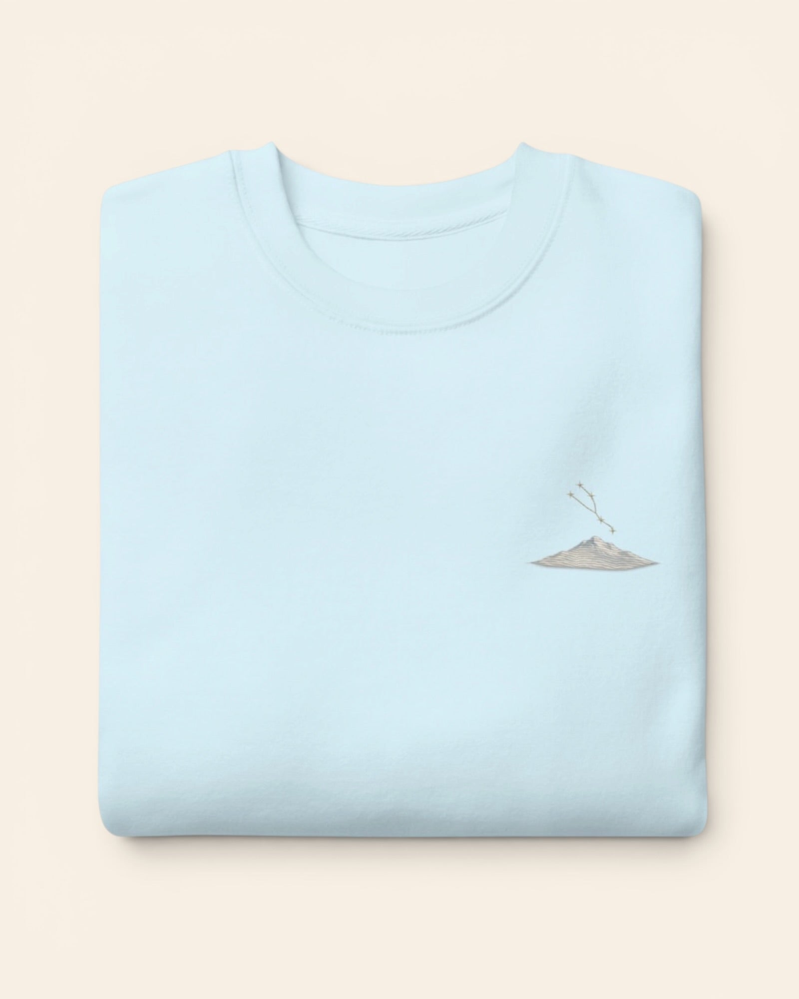 Taurus constellation crewneck sweatshirt with embroidered stars above a mountain ridge, in Sky Blue