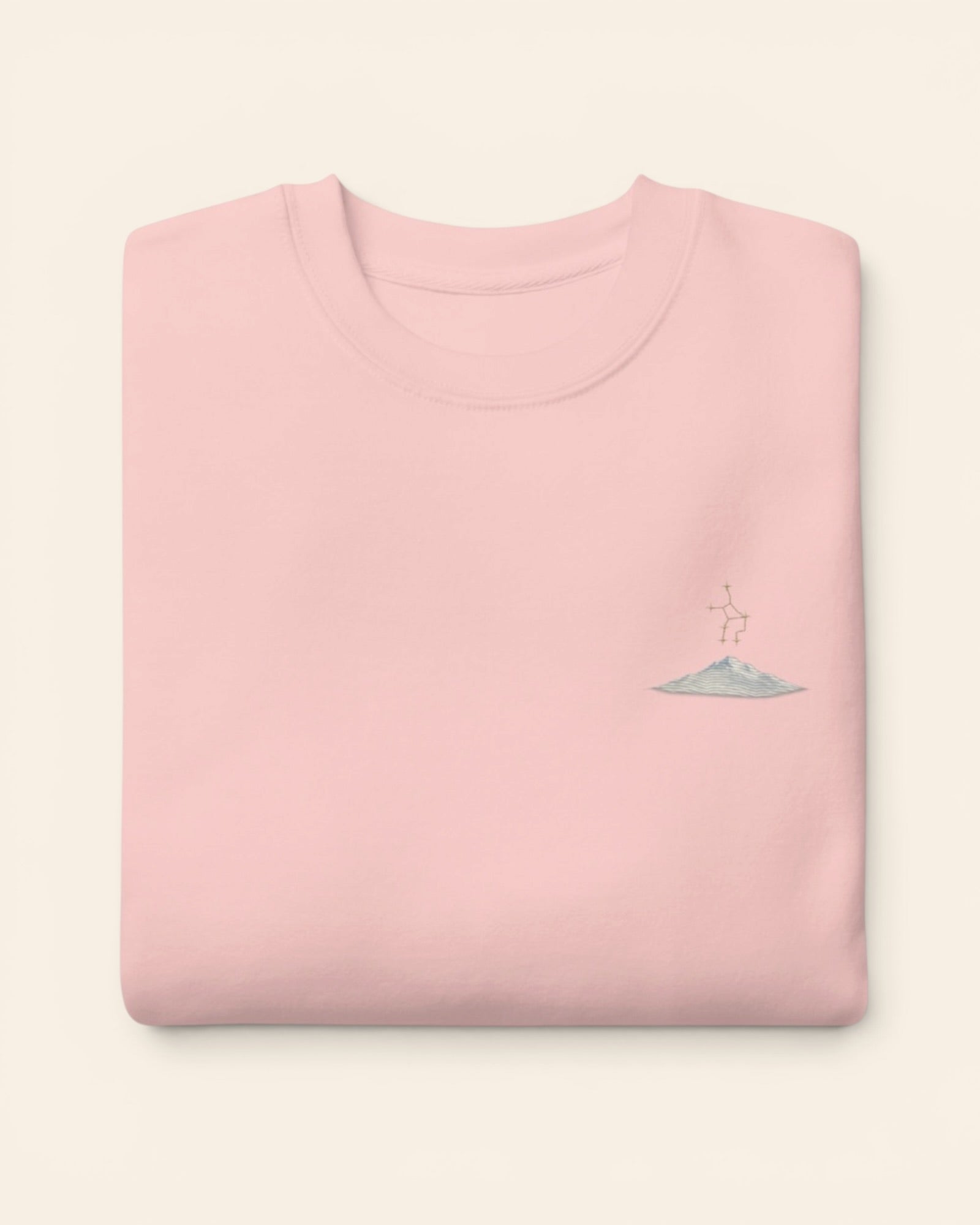 Virgo constellation crewneck sweatshirt with embroidered stars above a mountain ridge, in Light Pink