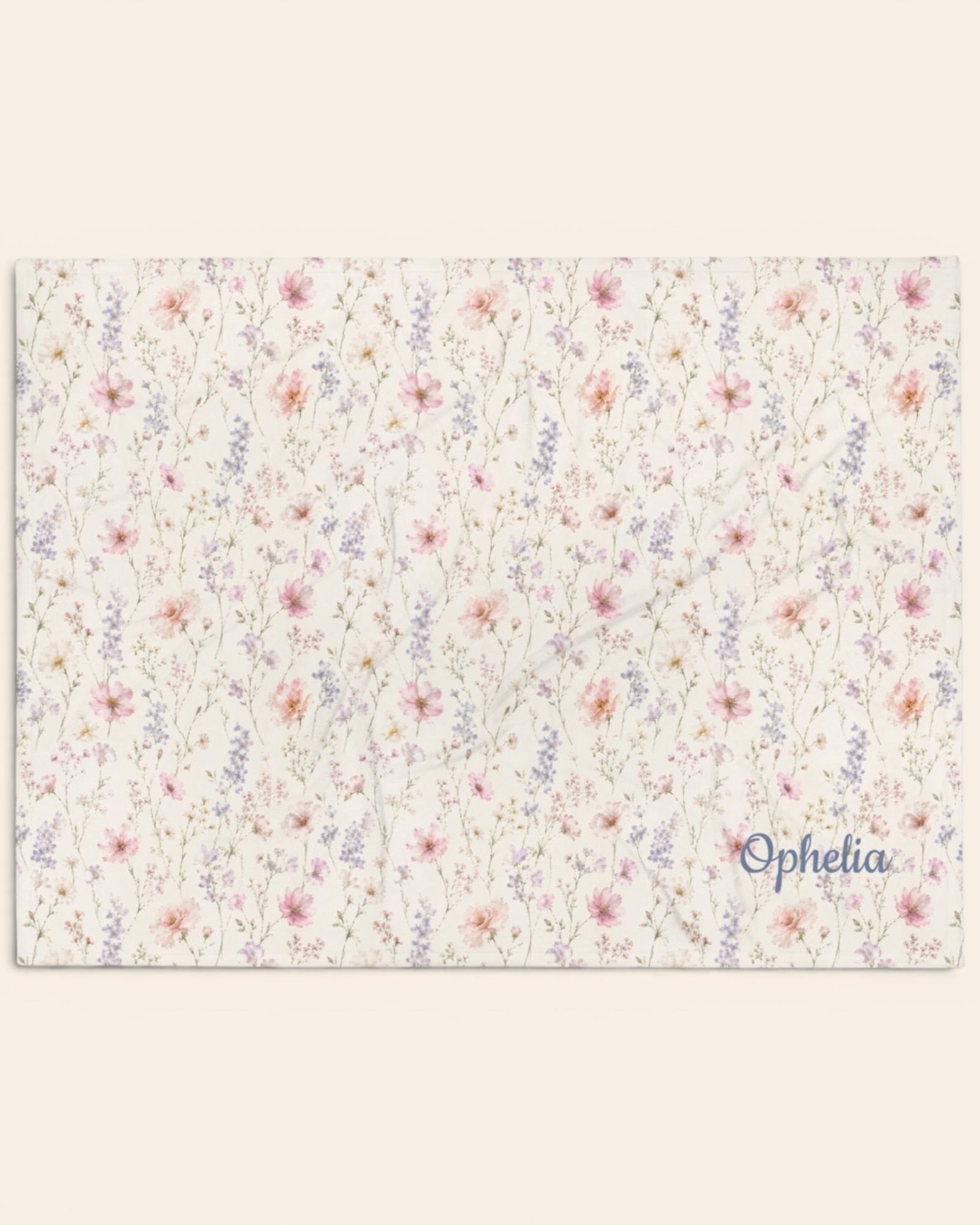 The Wildflower Theory Throw Blanket, with blush cosmos, cottage roses, larkspur, and baby's breath print