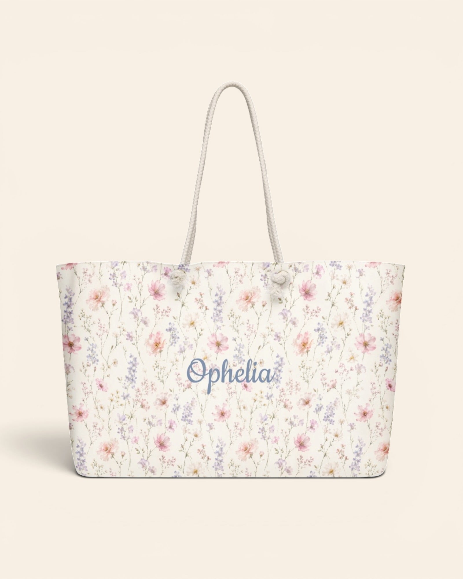The Wildflower Theory Weekender Bag, with blush cosmos, cottage roses, larkspur, and baby's breath print